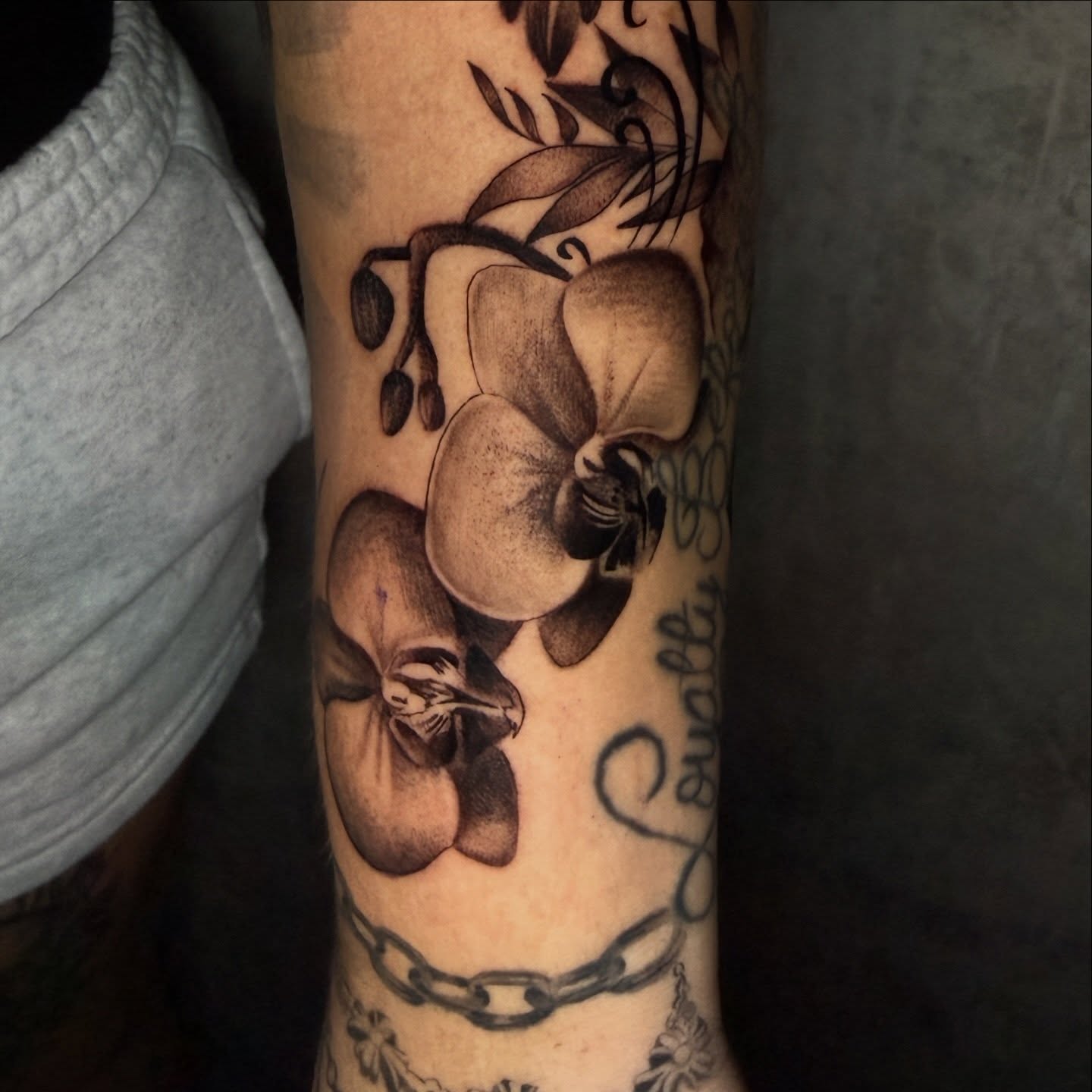 Orchids realism tattoo on the forearm by Chip