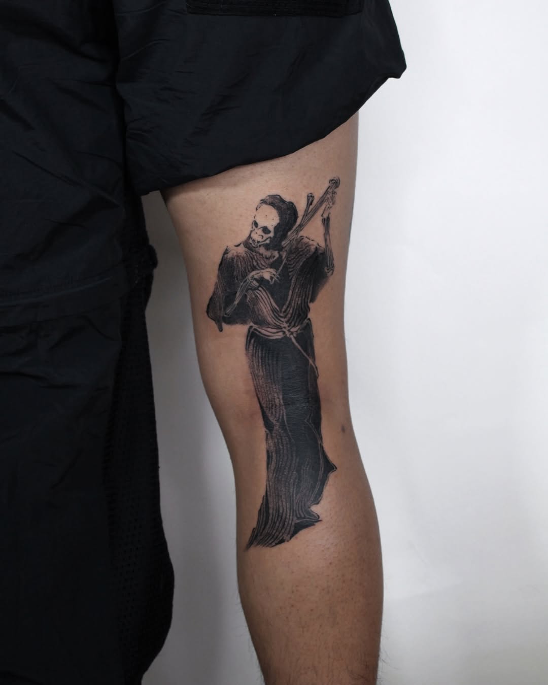 Skeleton playing violin dark art tattoo on the thigh by Piao