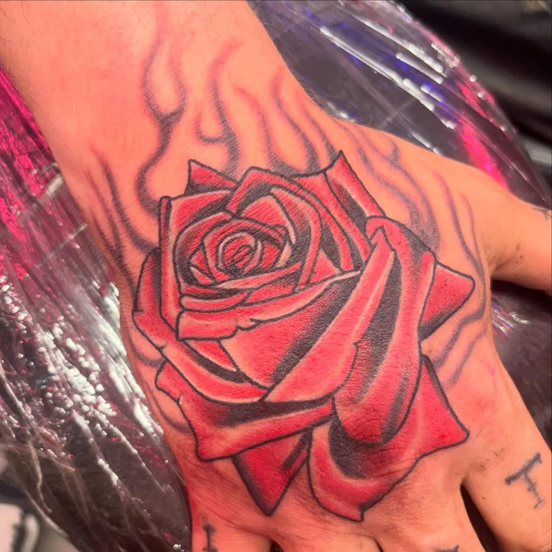 Rose with flames neo-traditional tattoo on the forearm by @dannydoestattoos