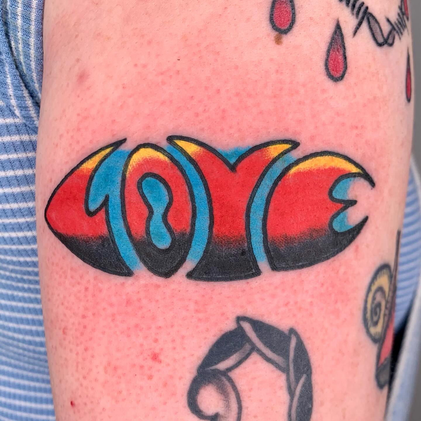 LOVE American traditional tattoo on the forearm by Keegan Bergen