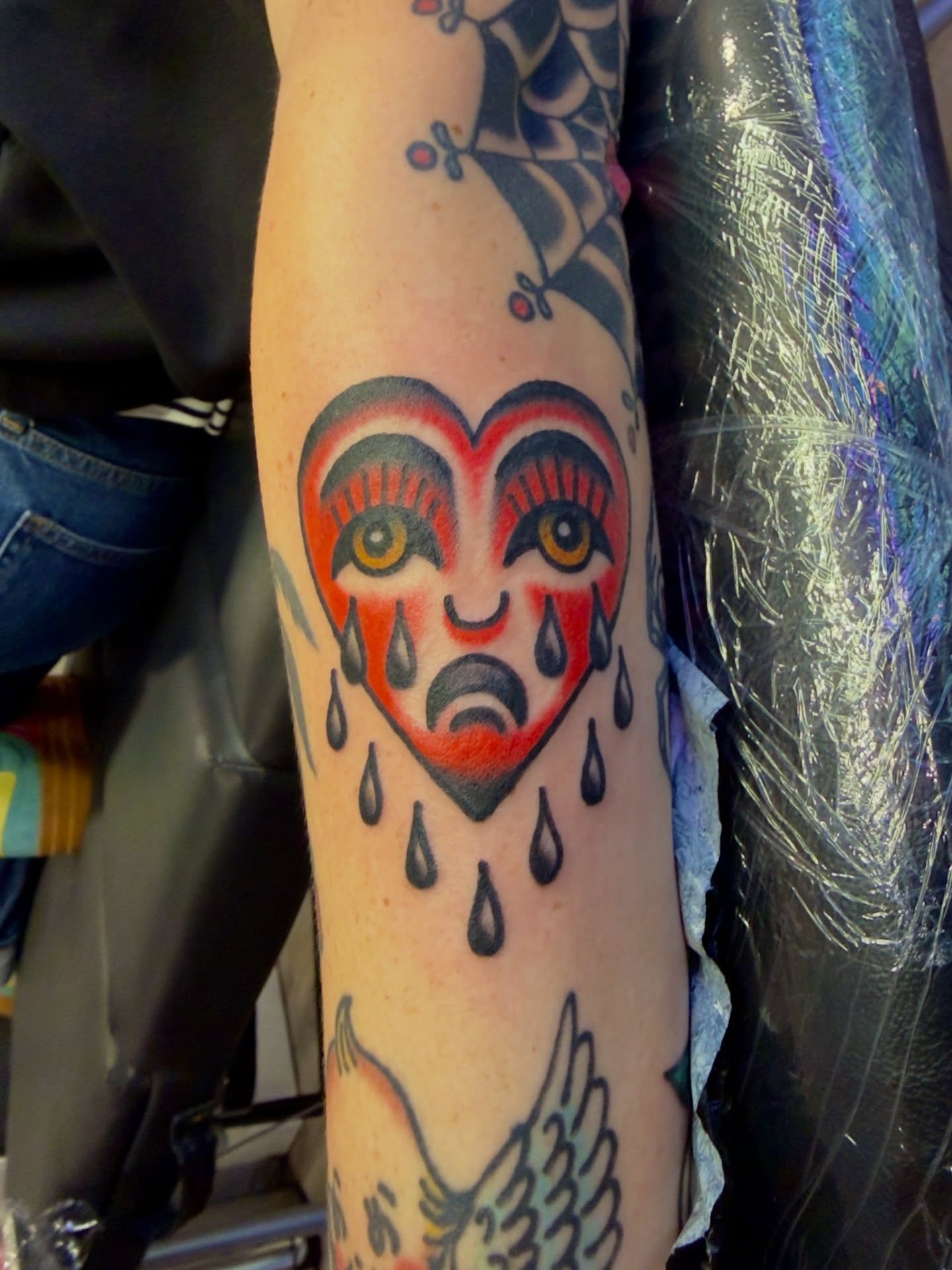 Clown face American traditional tattoo on the forearm by Jimmy Kelley