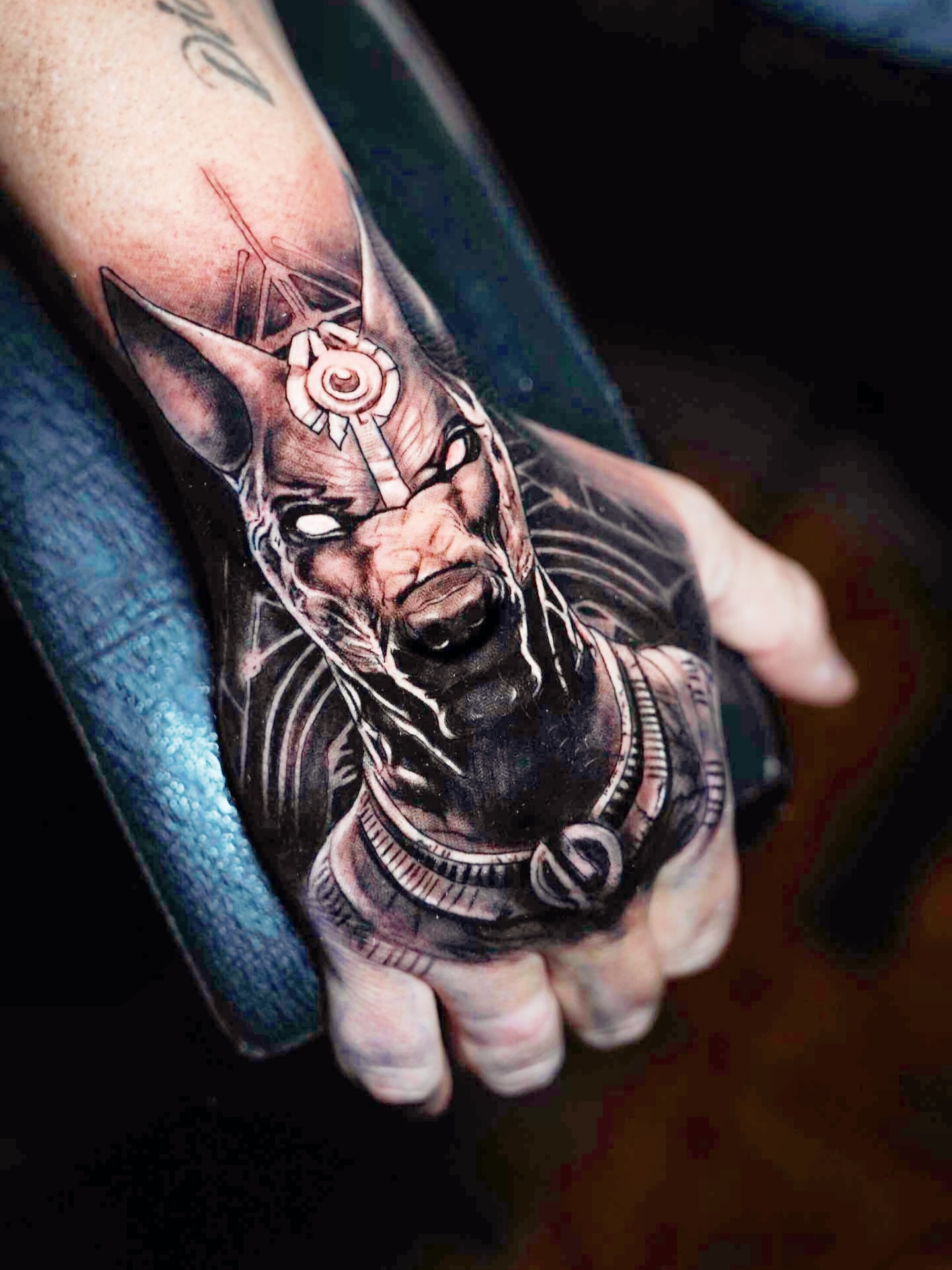 Warrior mask realism tattoo on the hand by Elijah Tattoos, San Diego, California