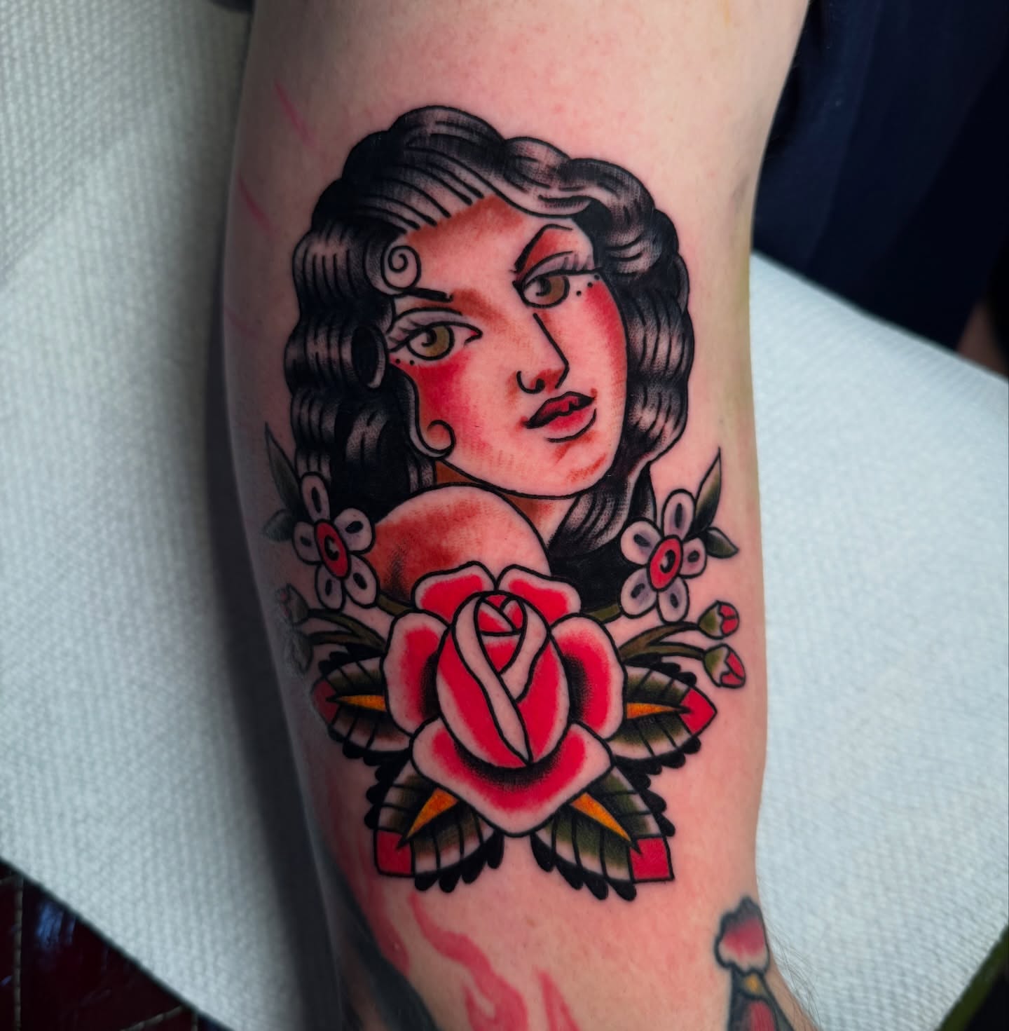 Woman with rose American traditional tattoo on the forearm by πππ’π―π’π¨ πππΆπ©π¬π―π, Manchester, New Hampshire