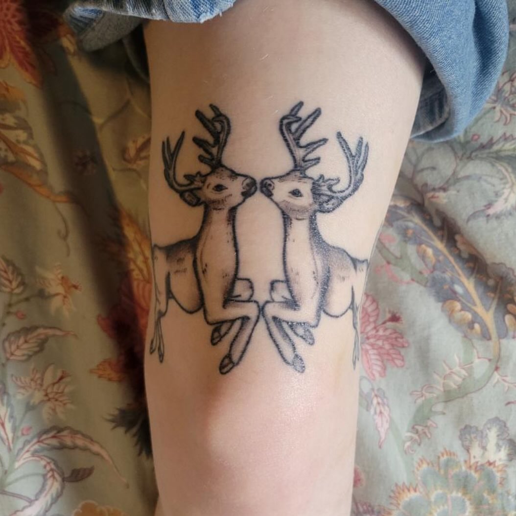 Deer couple black and grey tattoo on the thigh by Molly Dixon