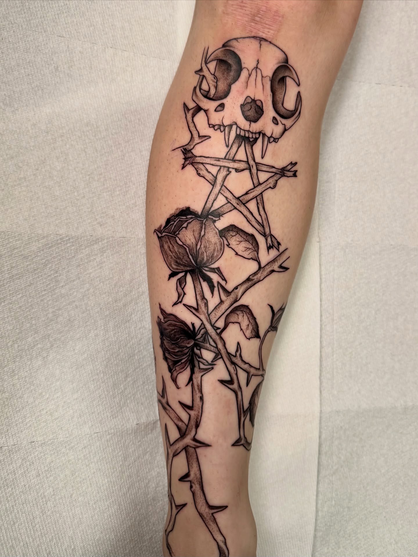 Skull and thorns dark realism tattoo on the forearm by Tatum