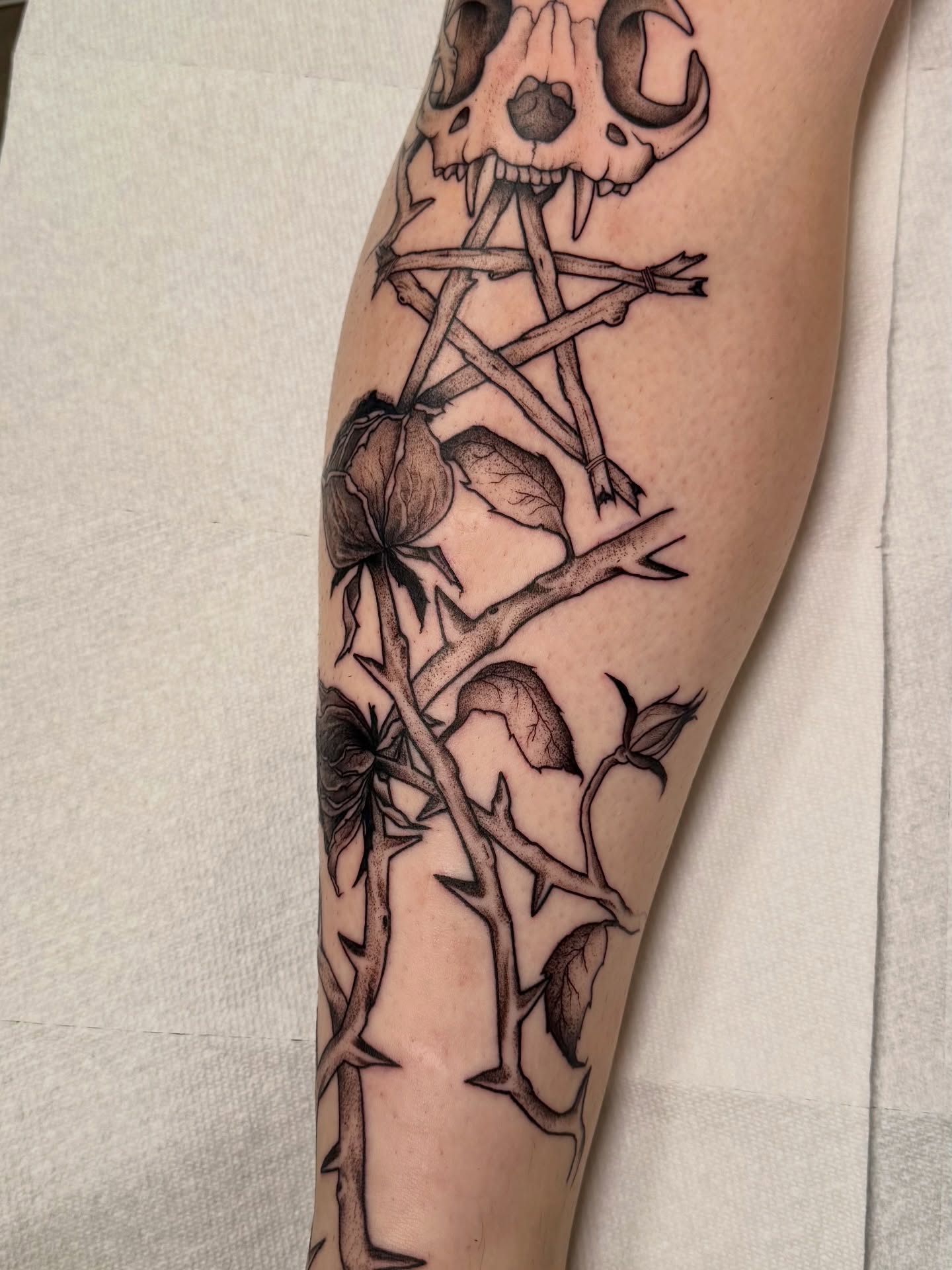 Skull and thorns realism tattoo on the forearm by Tatum
