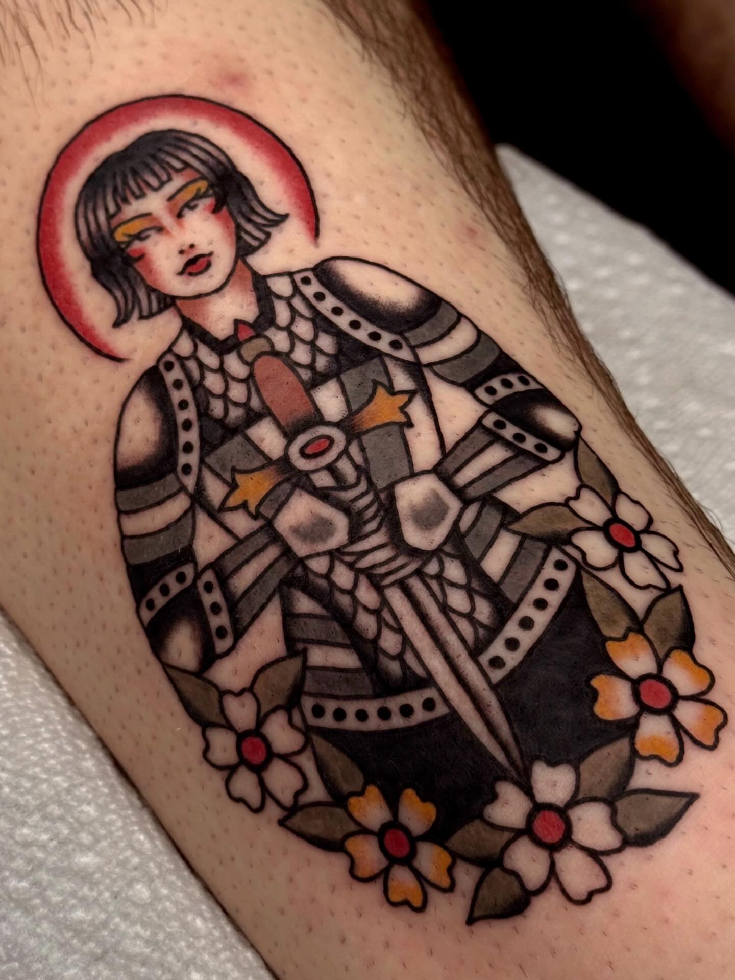 Female warrior with halo American traditional tattoo on the forearm by Bridgette Carberry