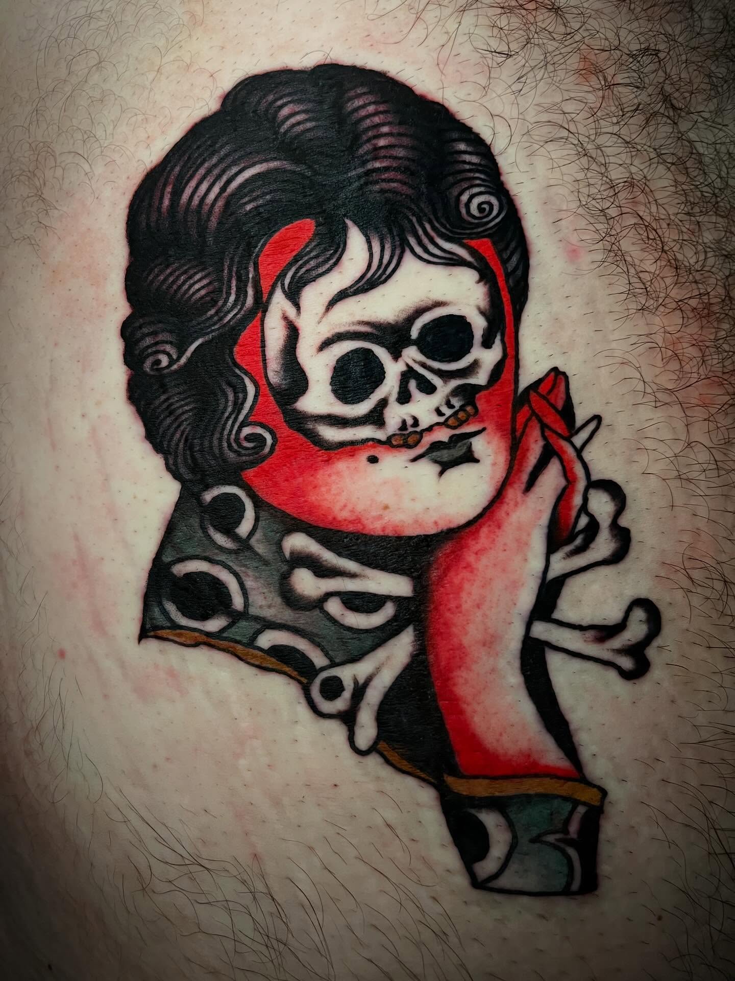 Skull with red scarf American traditional tattoo on the thigh by JohnJohn