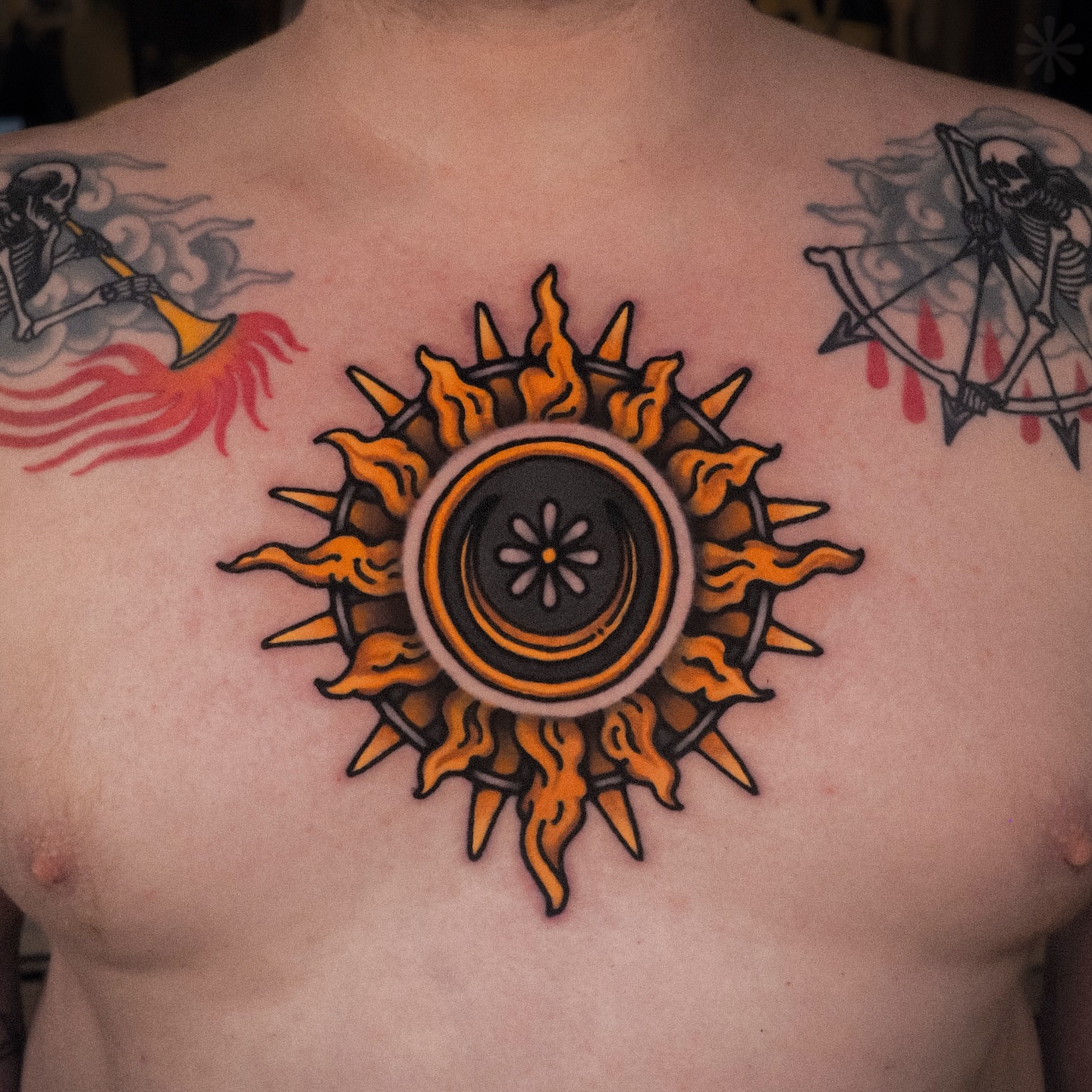 Flaming sun neo-traditional tattoo on the chest by Last Year Of Disaster
