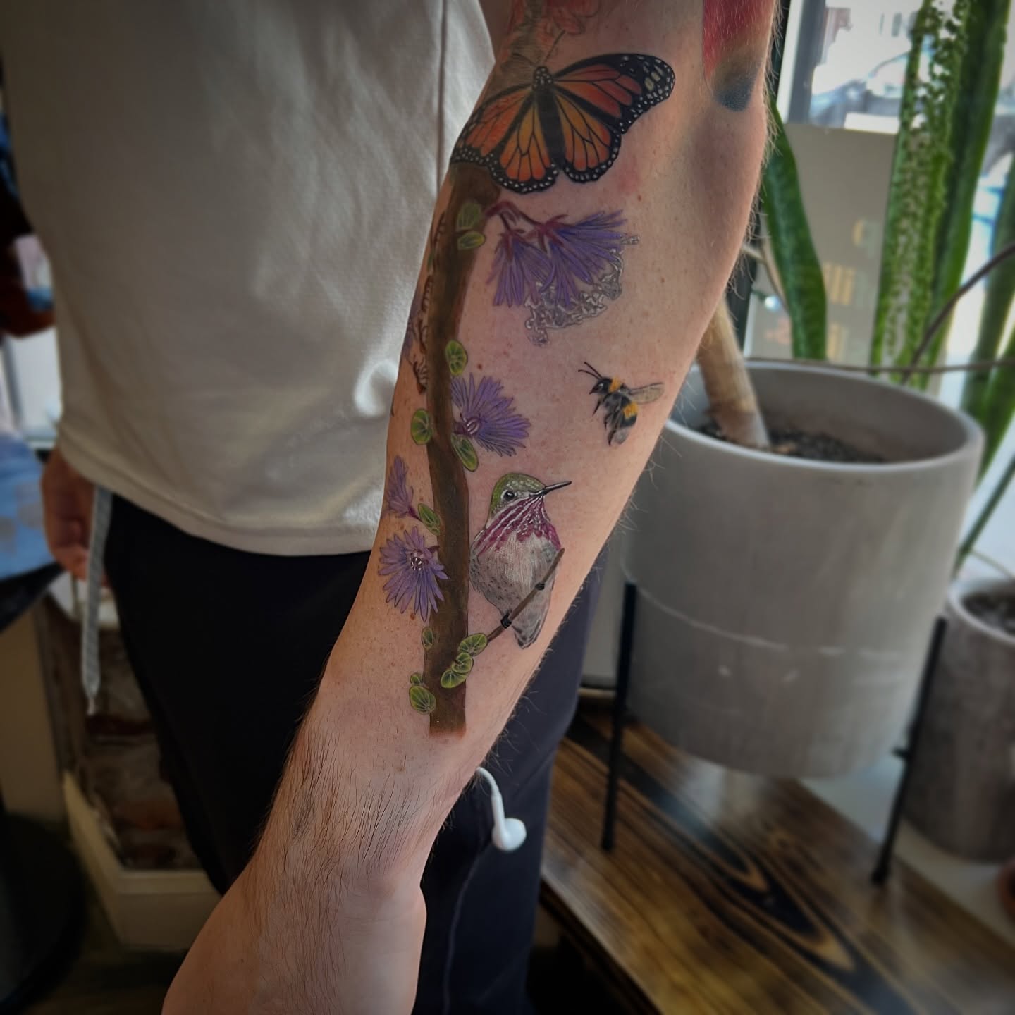 Bird and flowers realism tattoo on the forearm by Jen Rahman