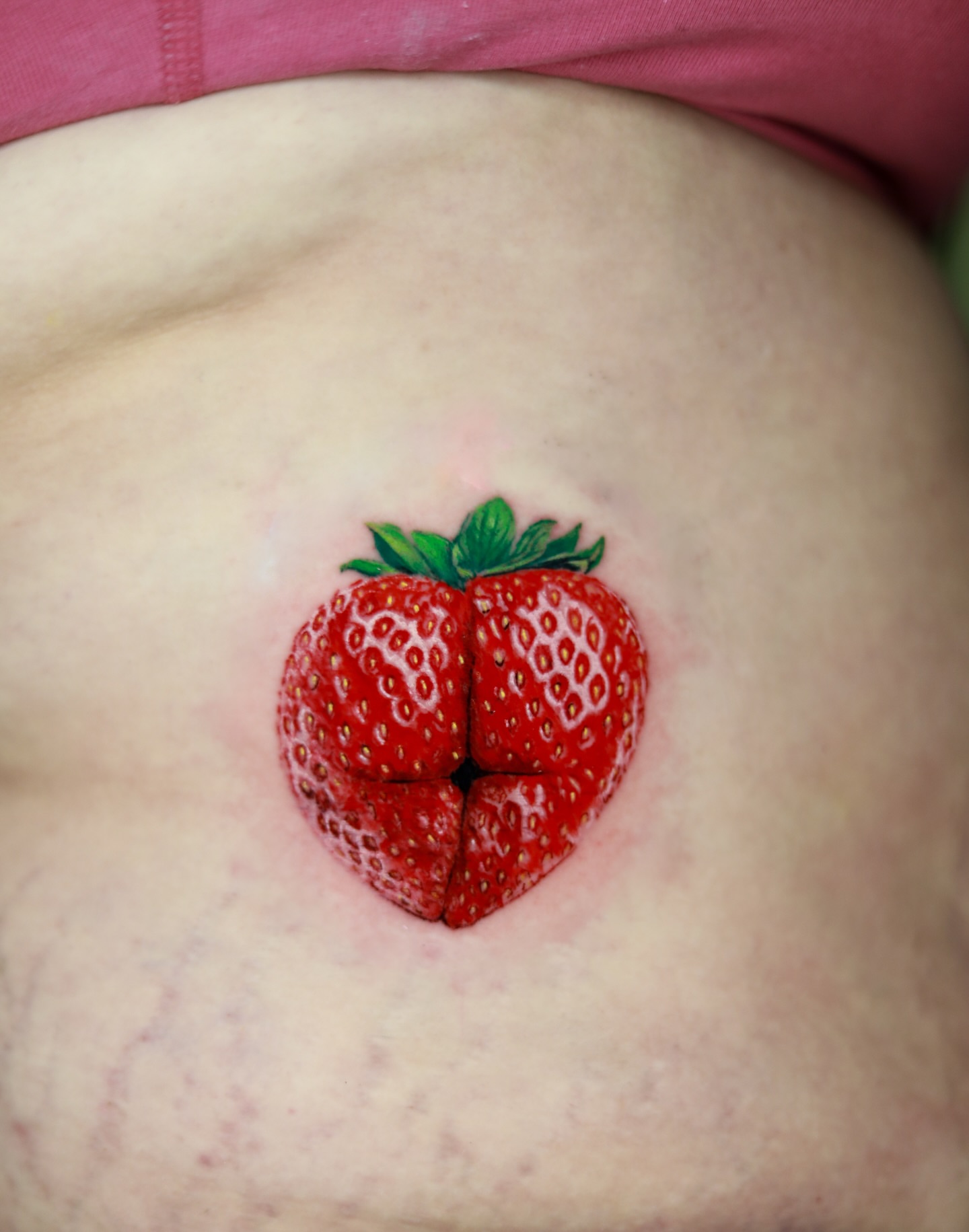 Strawberry realism tattoo on the torso by memo