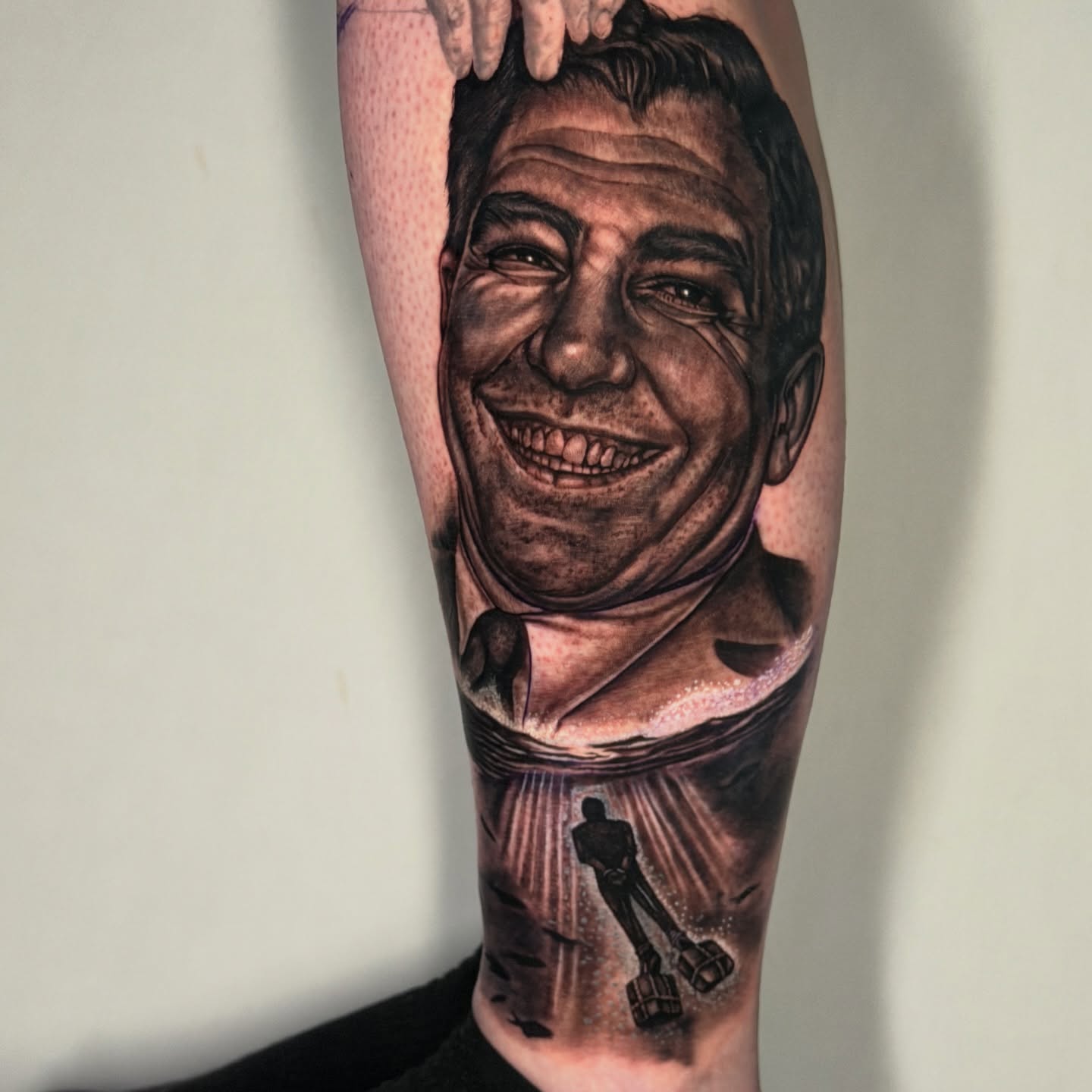 Portrait of a smiling man realism tattoo on the forearm by Adrian Dominguez, Las Vegas, Nevada