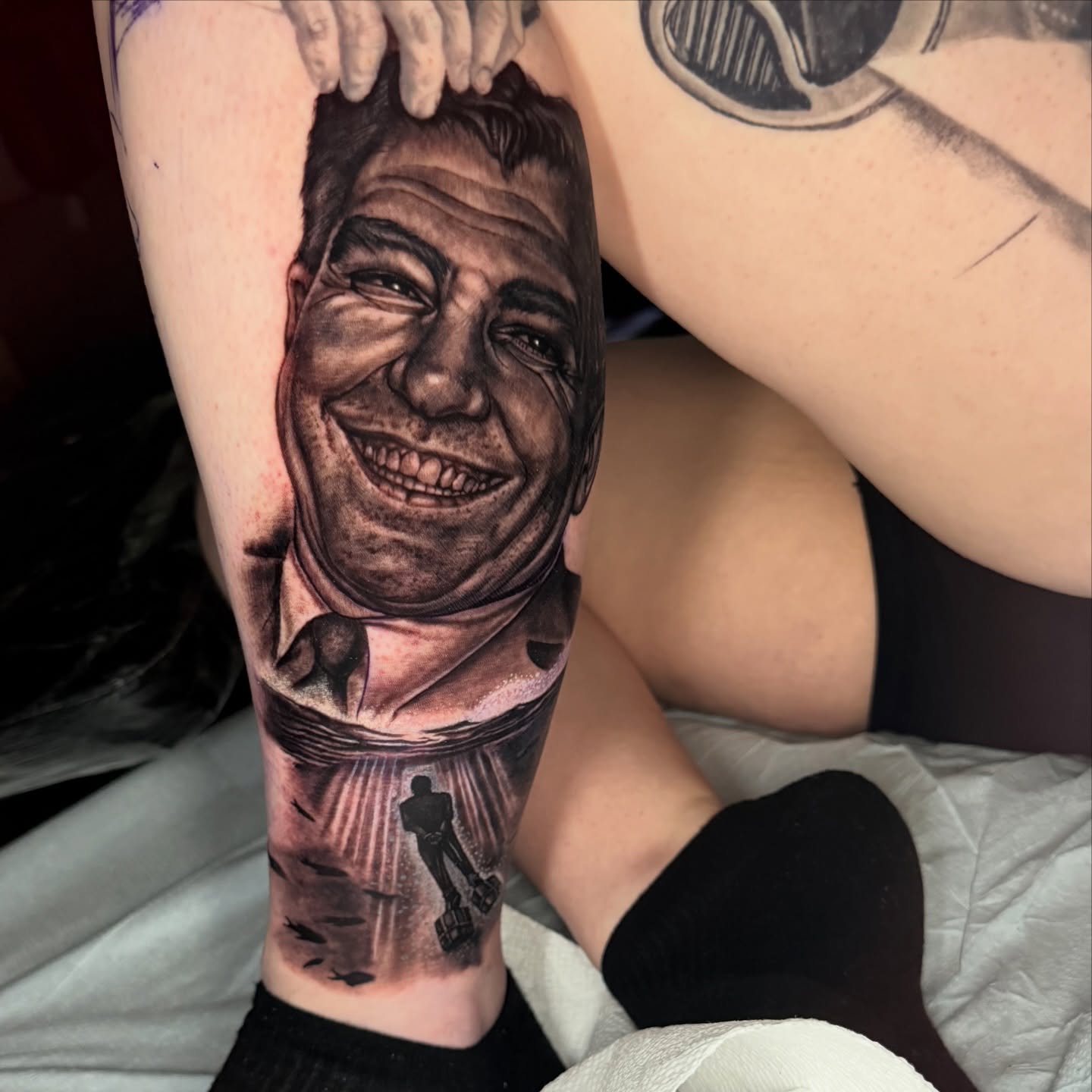 Portrait of a smiling man realism tattoo on the forearm by Adrian Dominguez, Las Vegas, Nevada