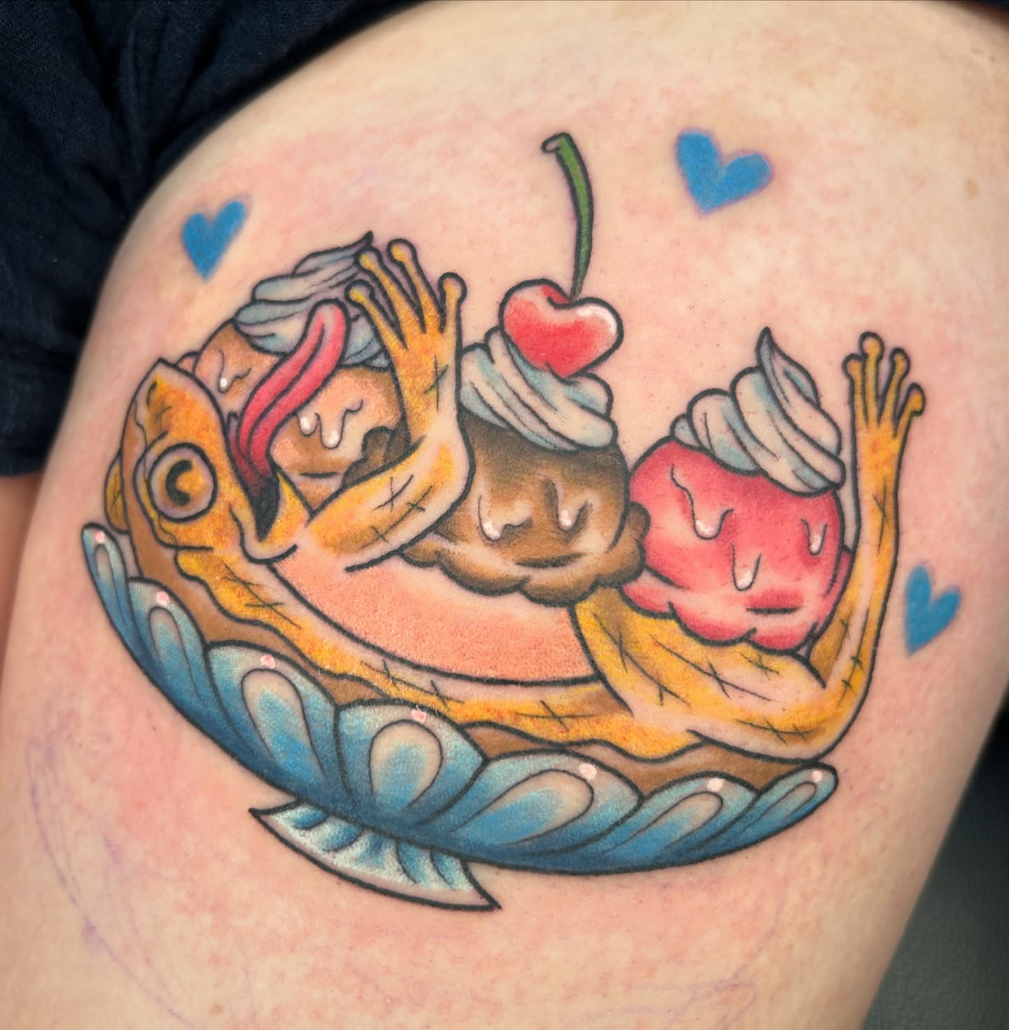Fish and cupcakes American traditional tattoo on the shoulder by Audrey Migitsch