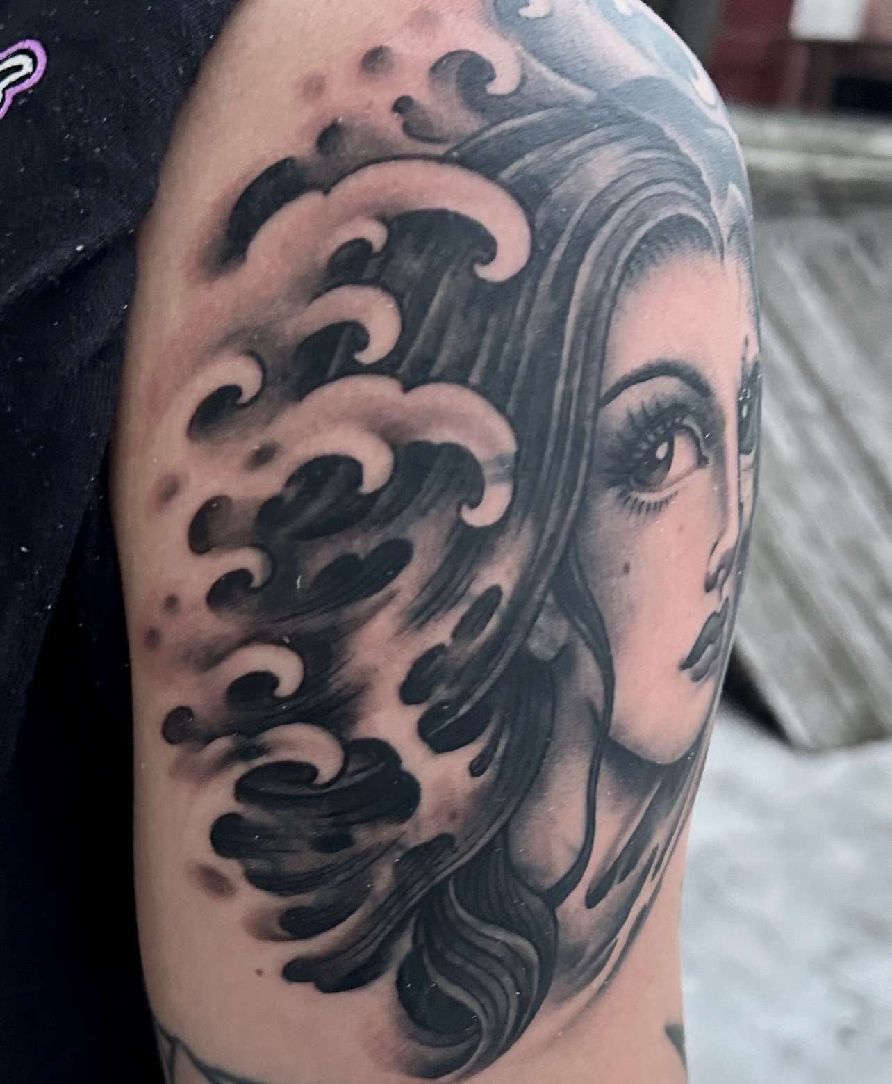 Woman's face with waves realism tattoo on the forearm by Justin Weatherholtz, New York, New York