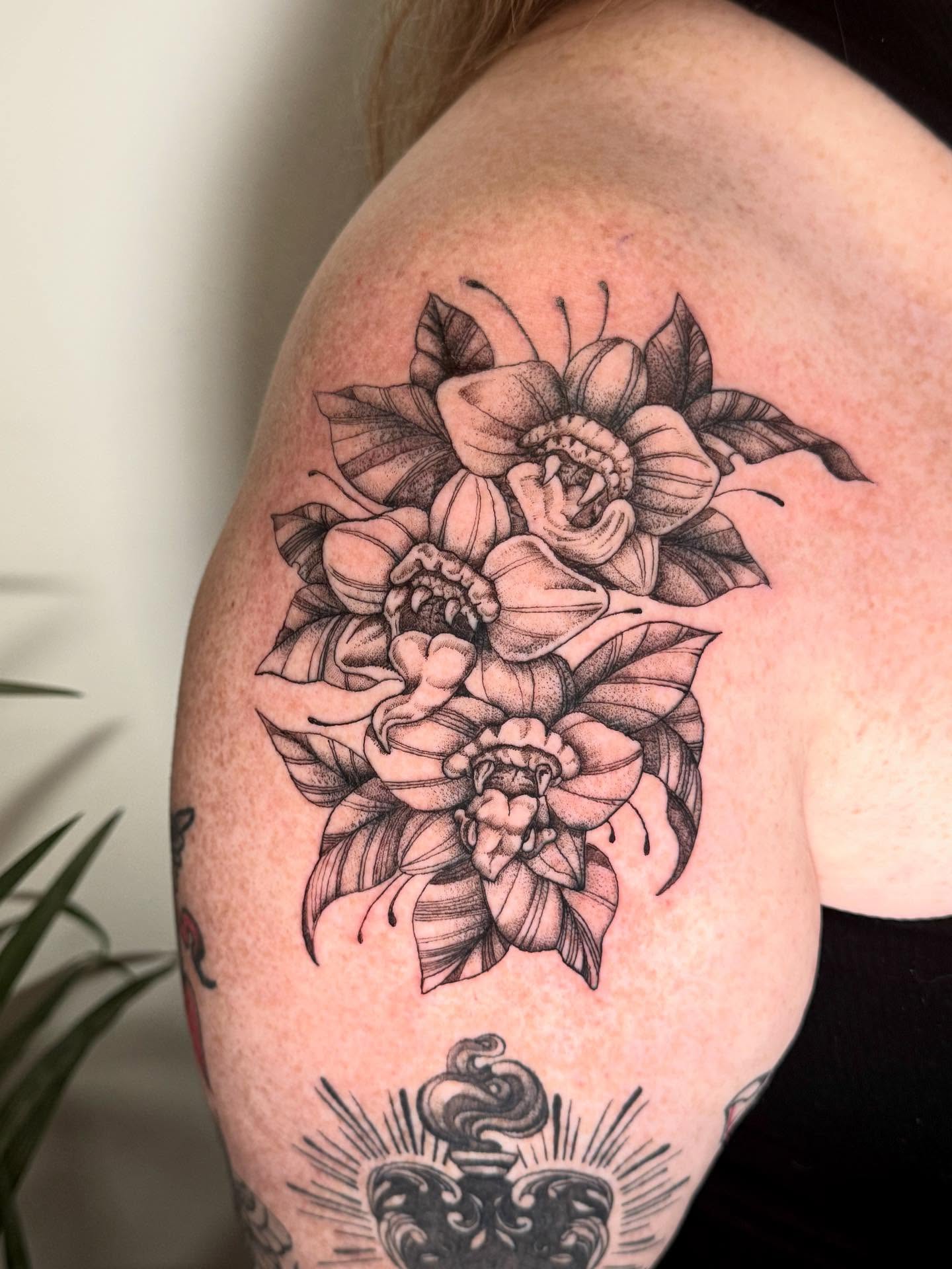 Floral bouquet black and grey tattoo on the shoulder by C.J. Pennington