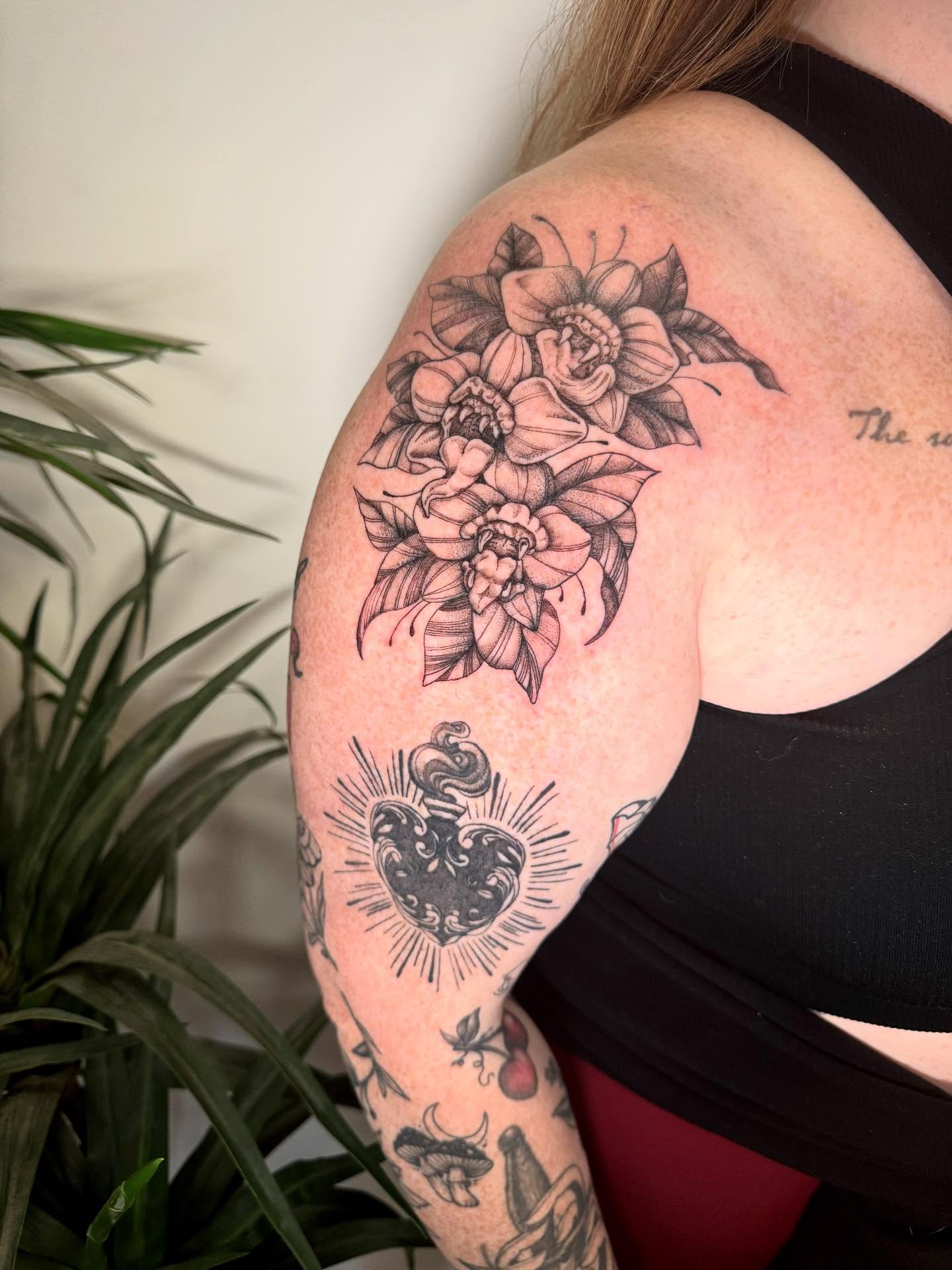 Floral bouquet black and grey tattoo on the shoulder by C.J. Pennington