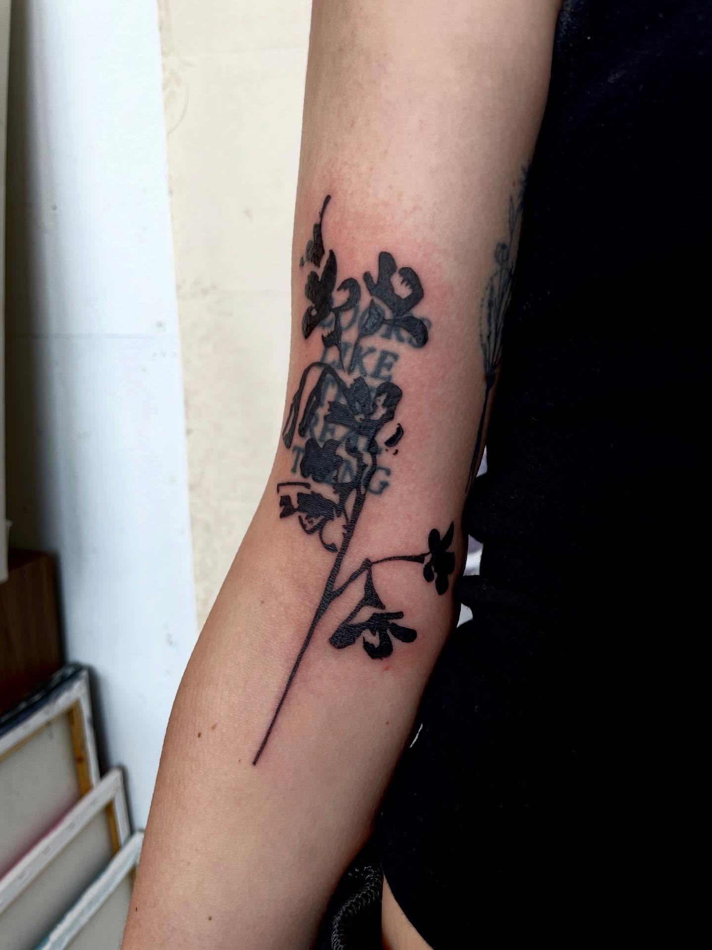 Flower and text black and grey tattoo on the forearm by bisabuelita