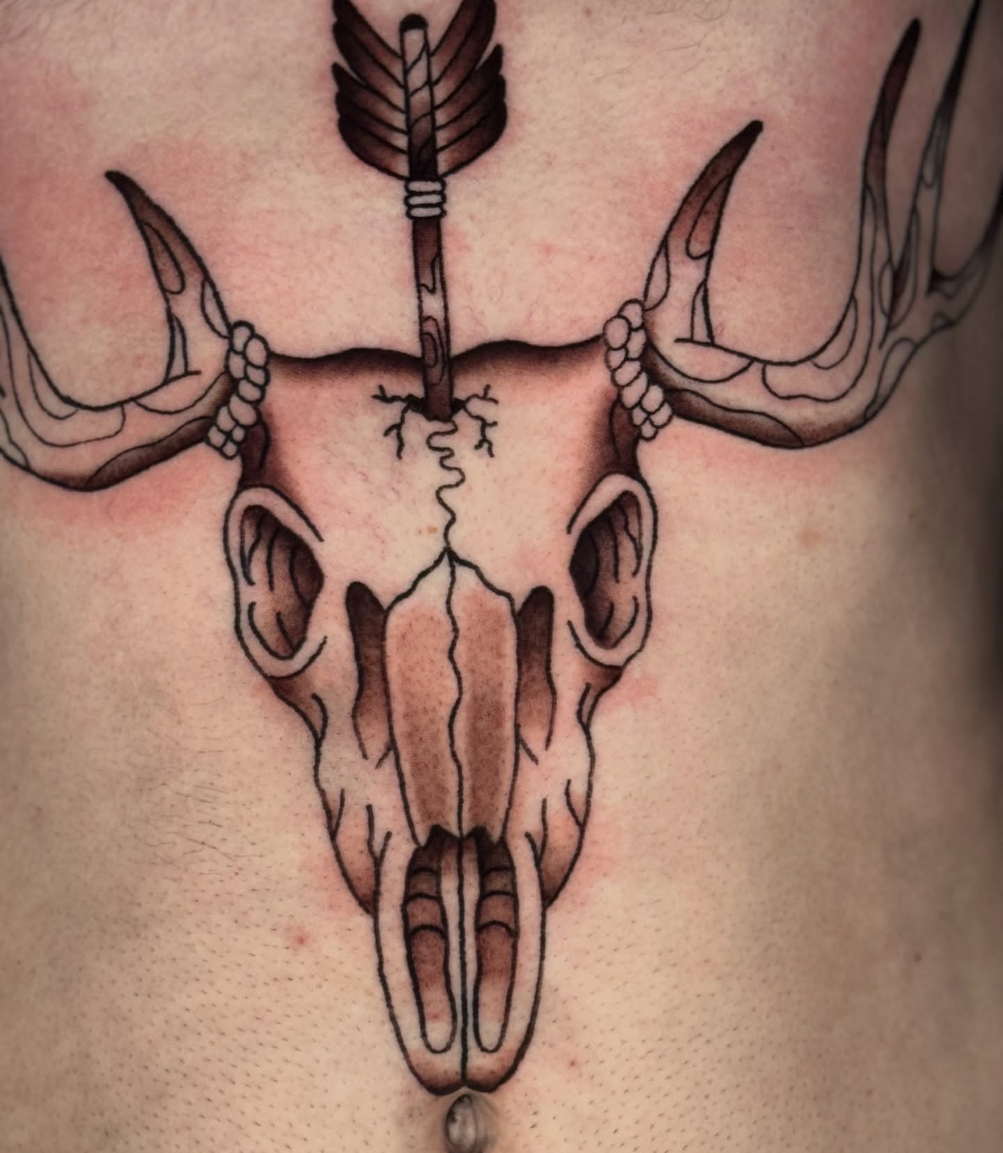 Deer skull with arrow realism tattoo on the chest by Celia