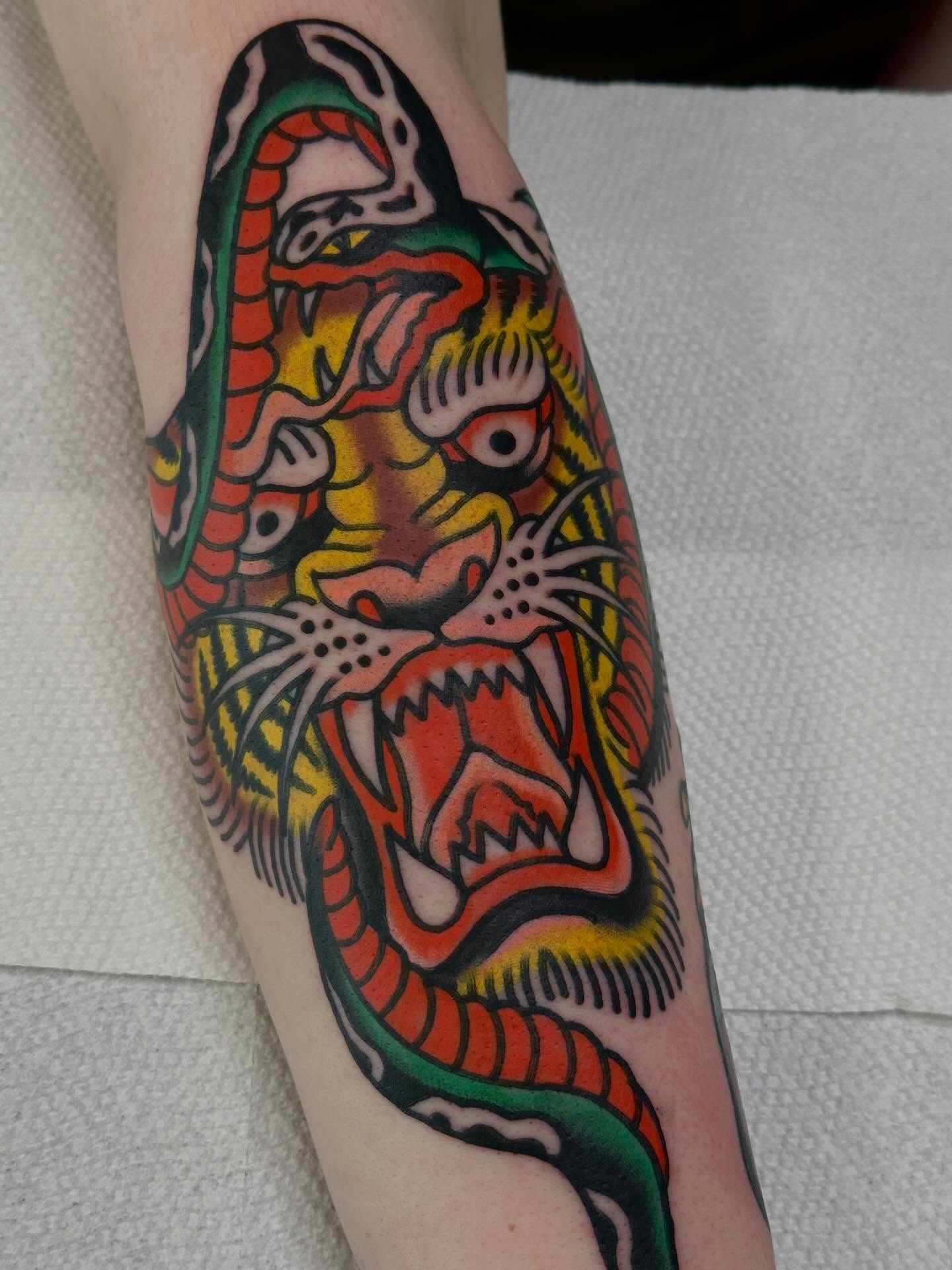 Snake American traditional tattoo on the forearm by Steve Pearson