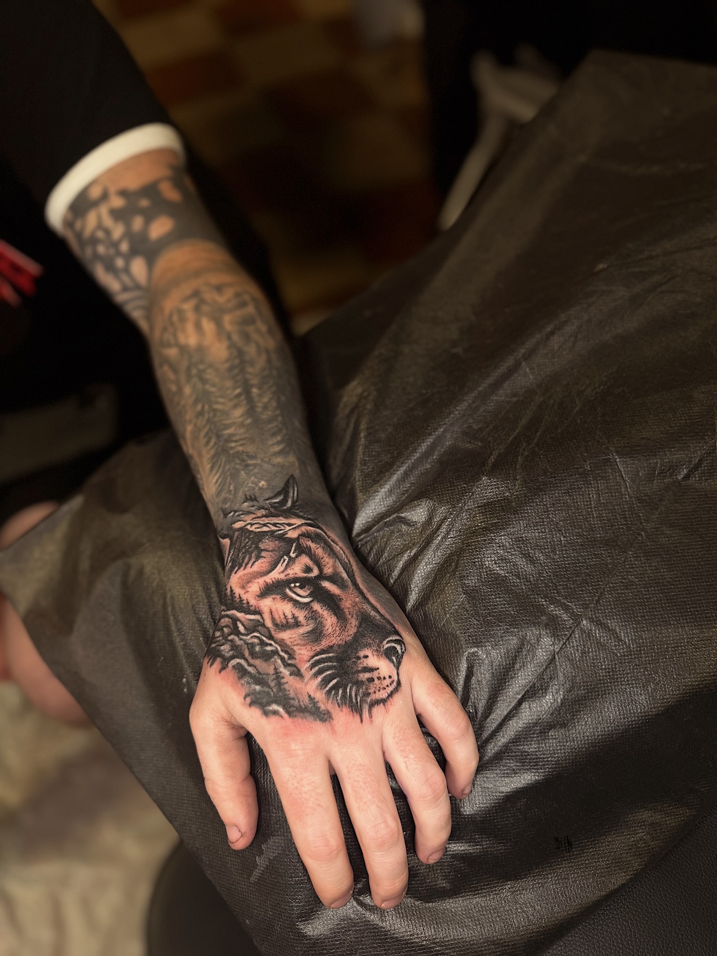 Tiger realism tattoo on the hand by Breanna Werner