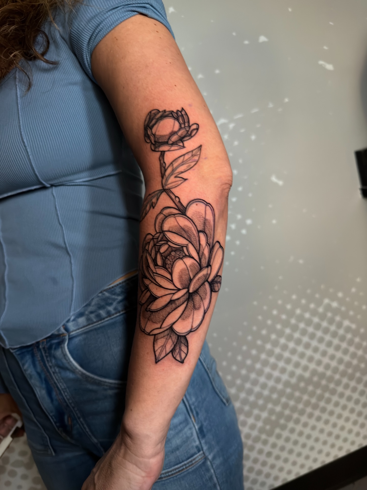 Peony black and grey tattoo on the forearm by Charlotte Tattoo Artist