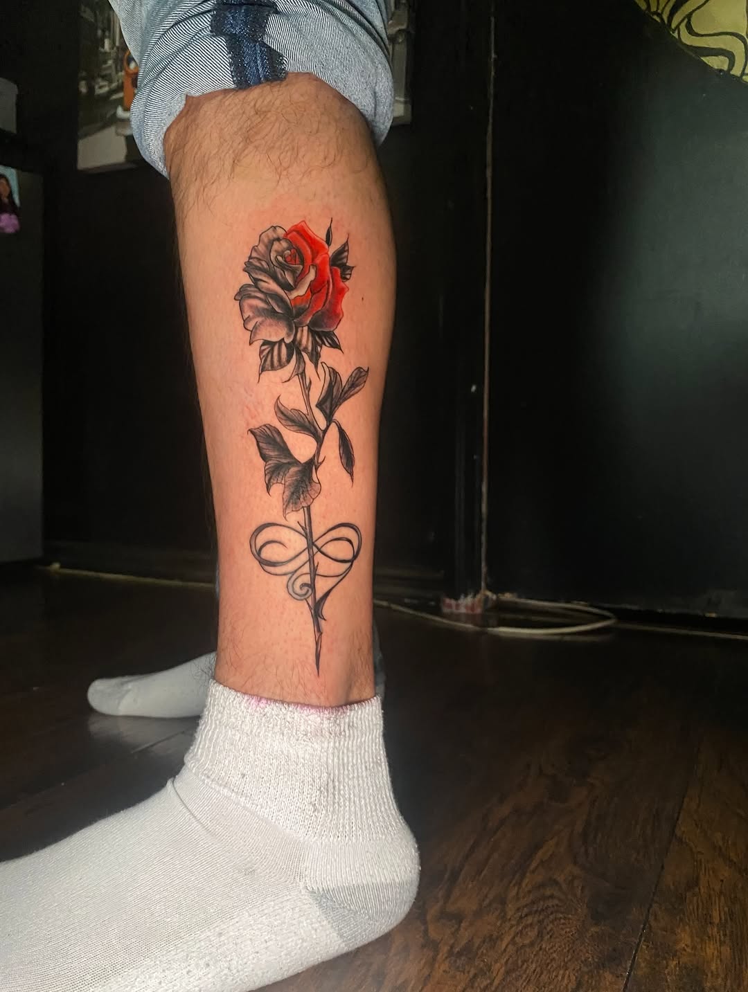 Rose with infinity symbol neo-traditional tattoo on the calf by Irving Guzman