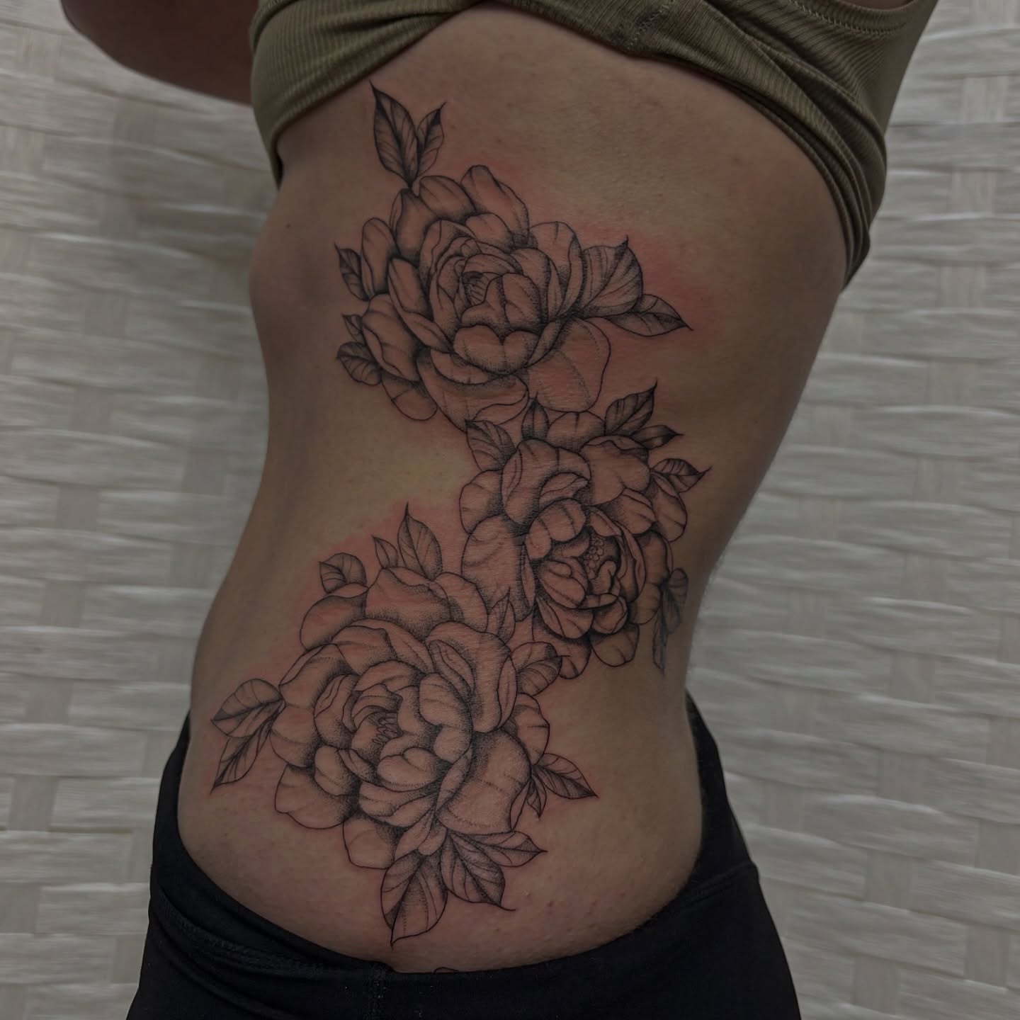 Roses black and grey tattoo on the ribs by Sydney Gallucci