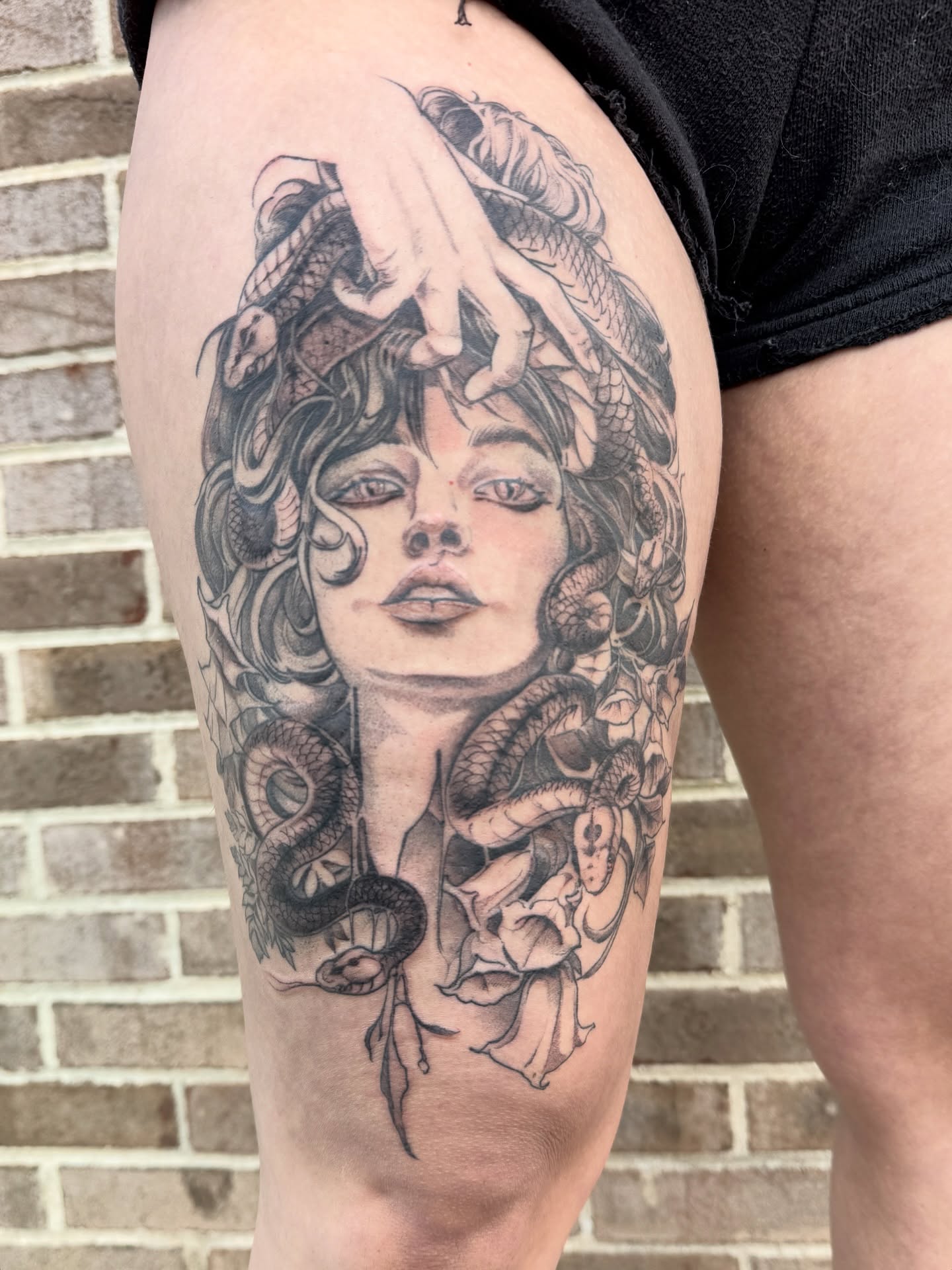 Medusa realism tattoo on the thigh by Joe Hall