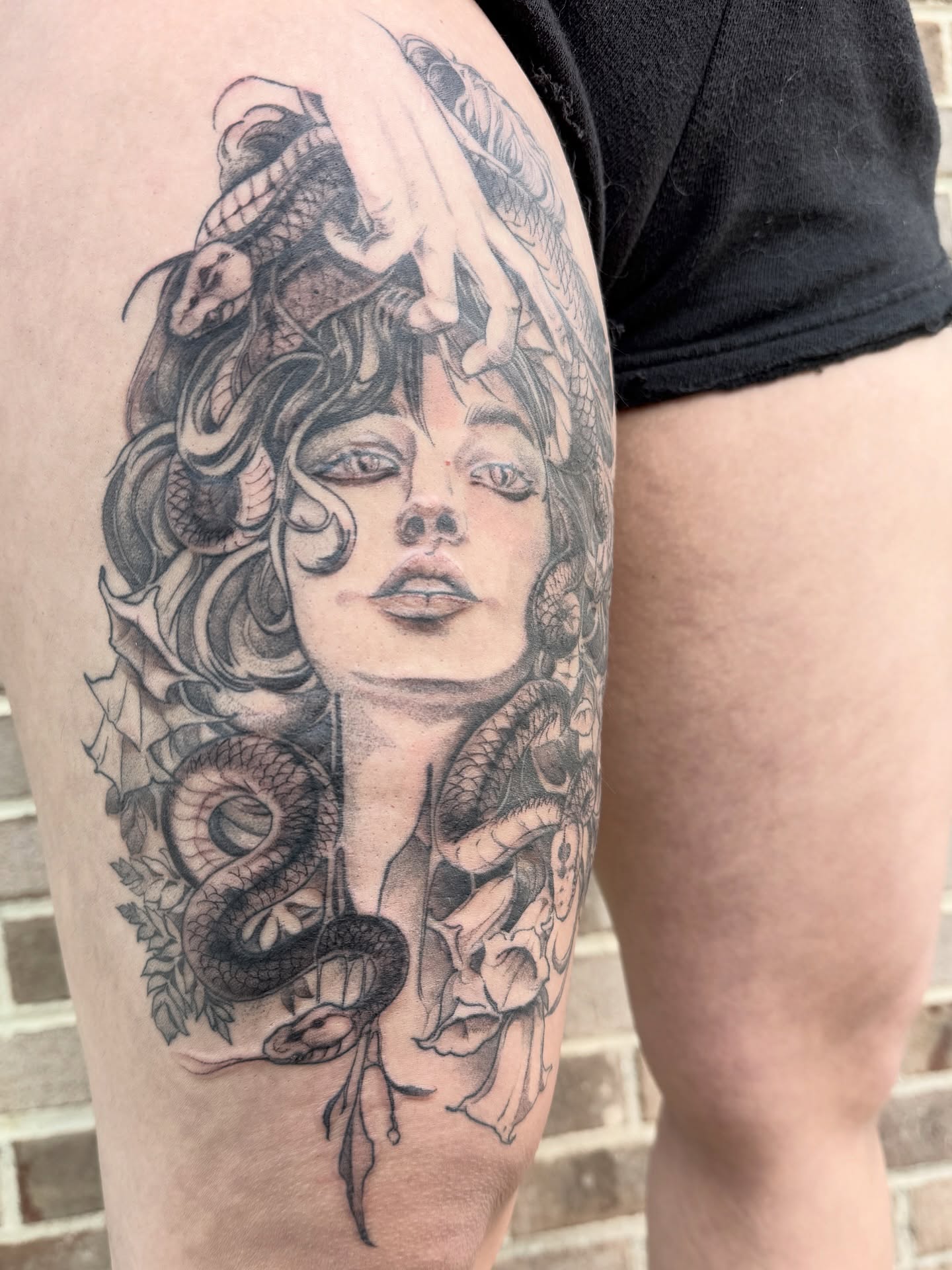 Medusa realism tattoo on the thigh by Joe Hall