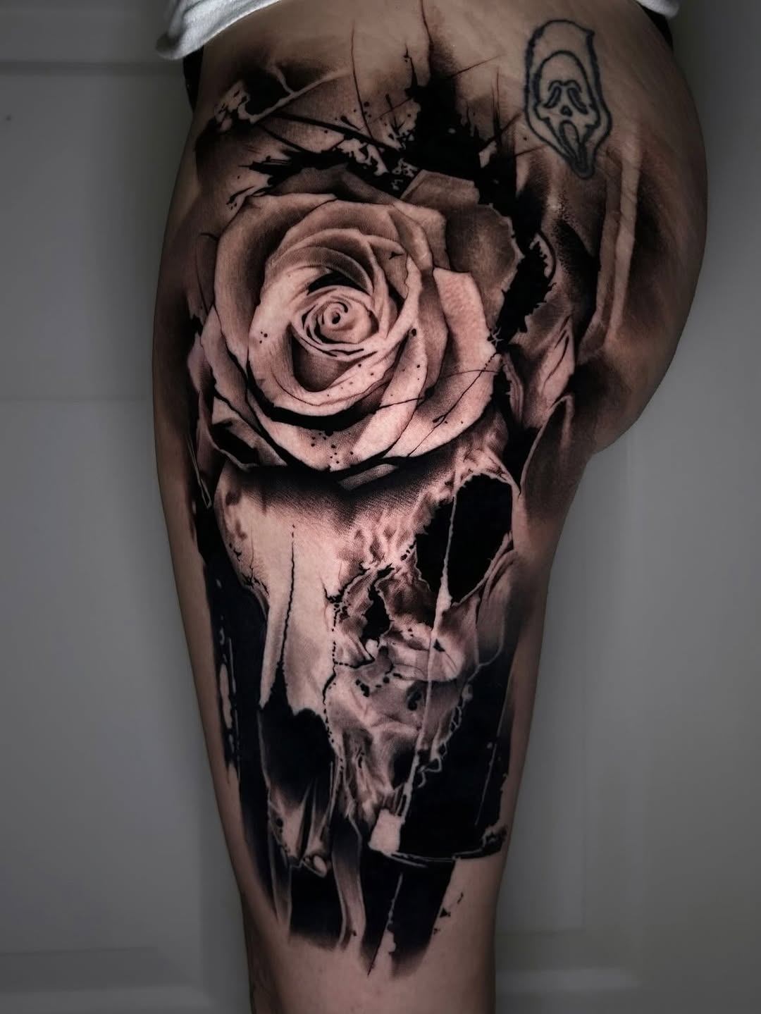 Rose and skull realism tattoo on the thigh by Dallas Corsmeier