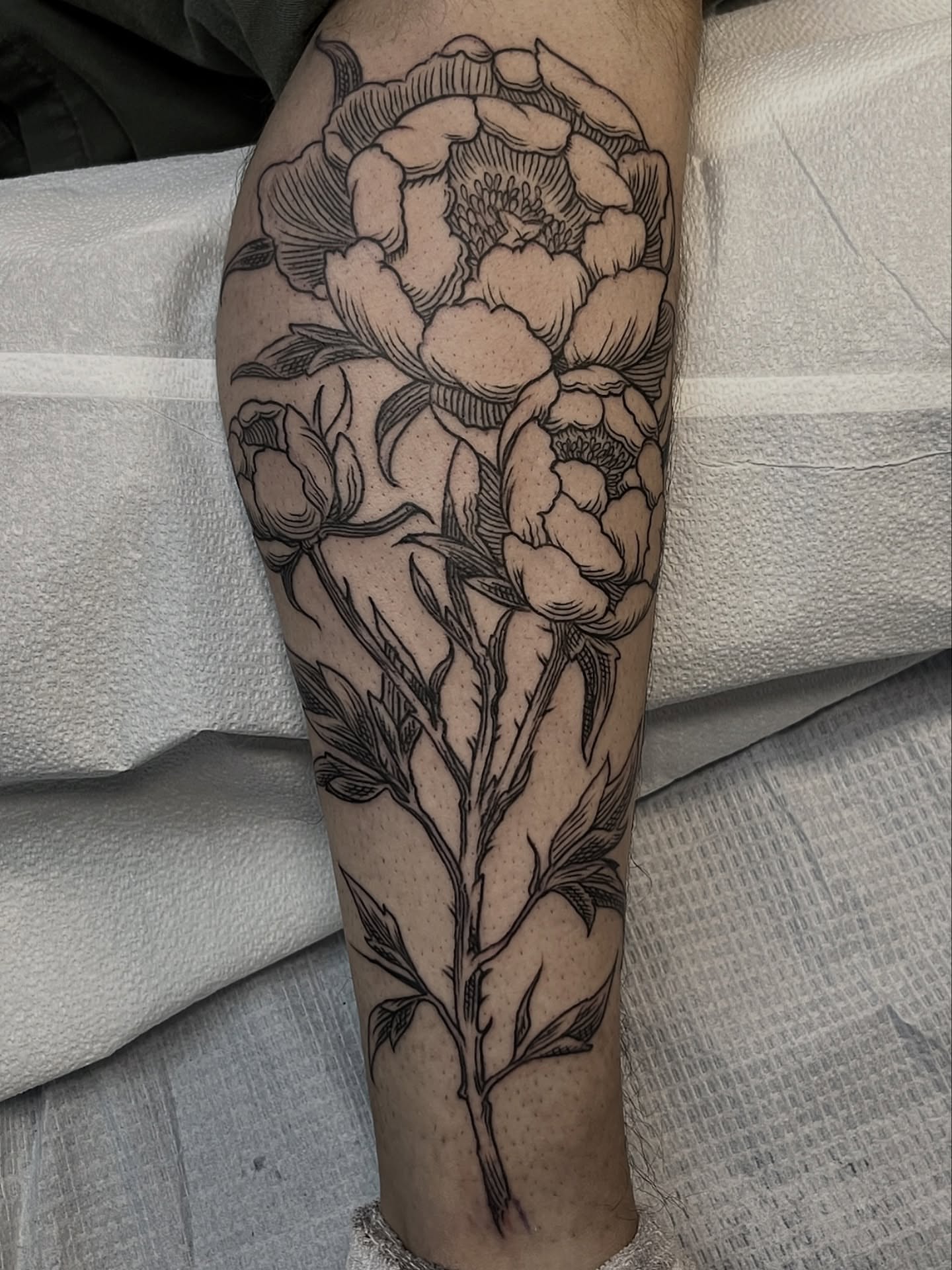 Peony flowers black and grey tattoo on the calf by Andrew Snowden