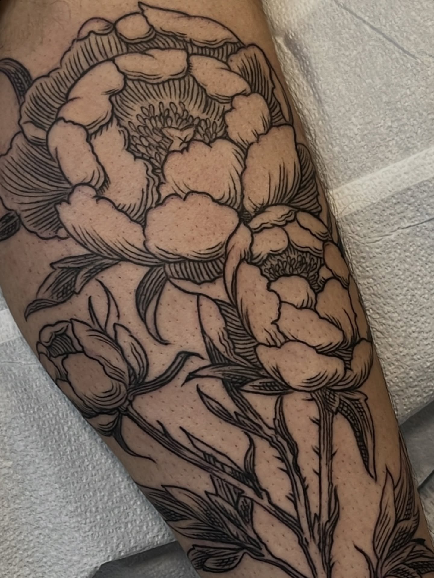 Peony black and grey tattoo on the forearm by Andrew Snowden