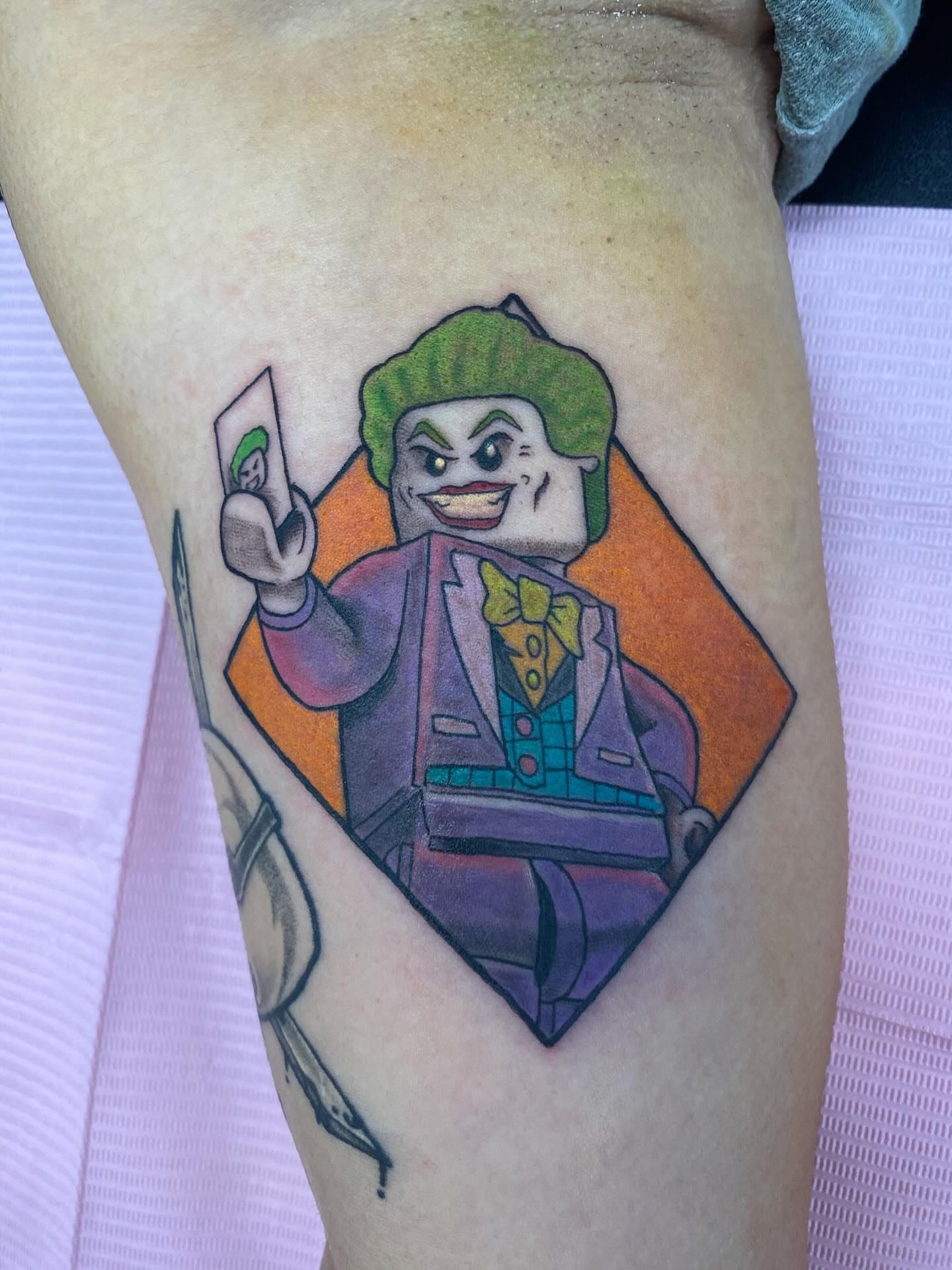 Joker character illustrative tattoo on the thigh by @artinjections667