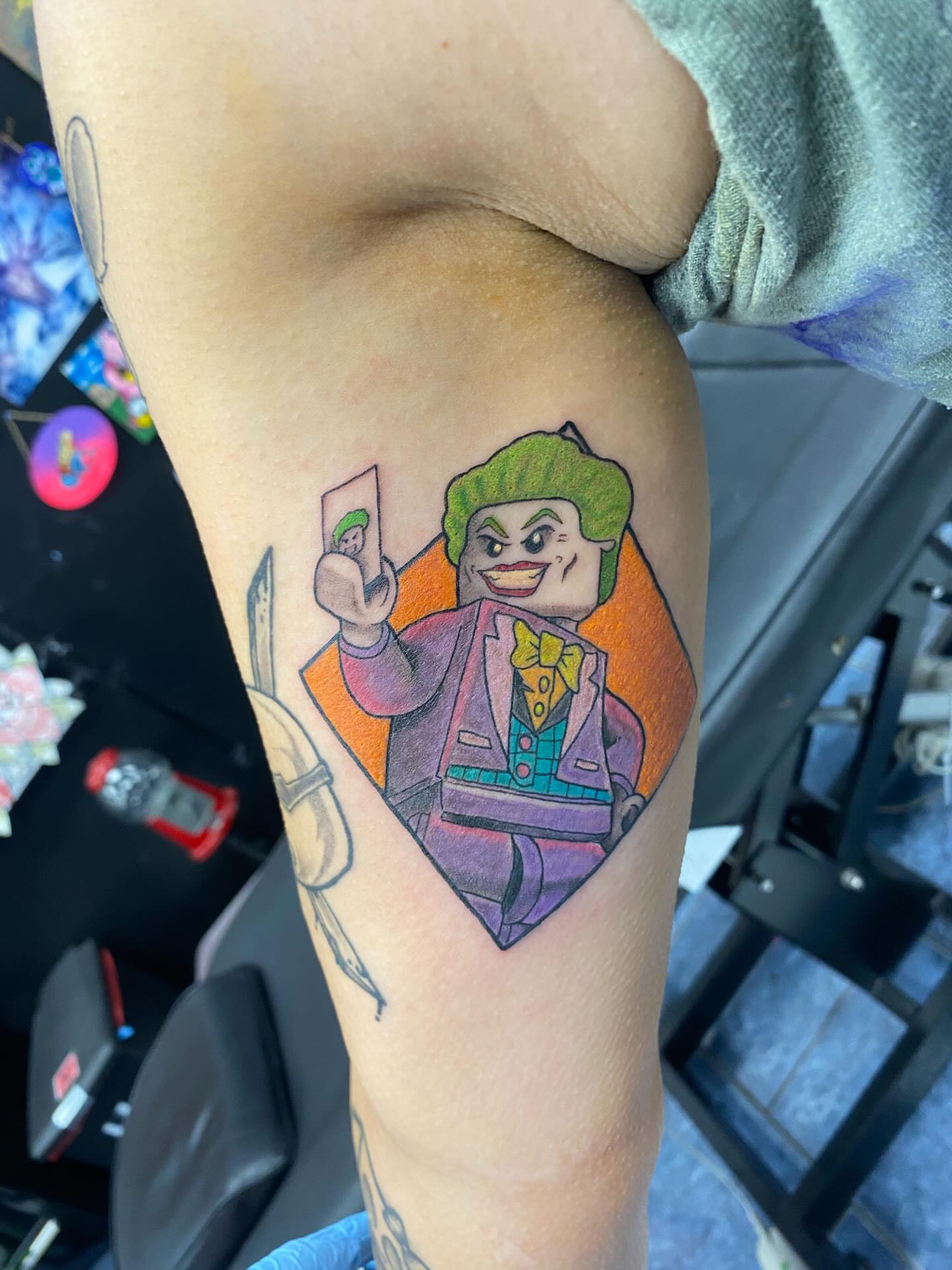 Joker character illustrative tattoo on the forearm by @artinjections667
