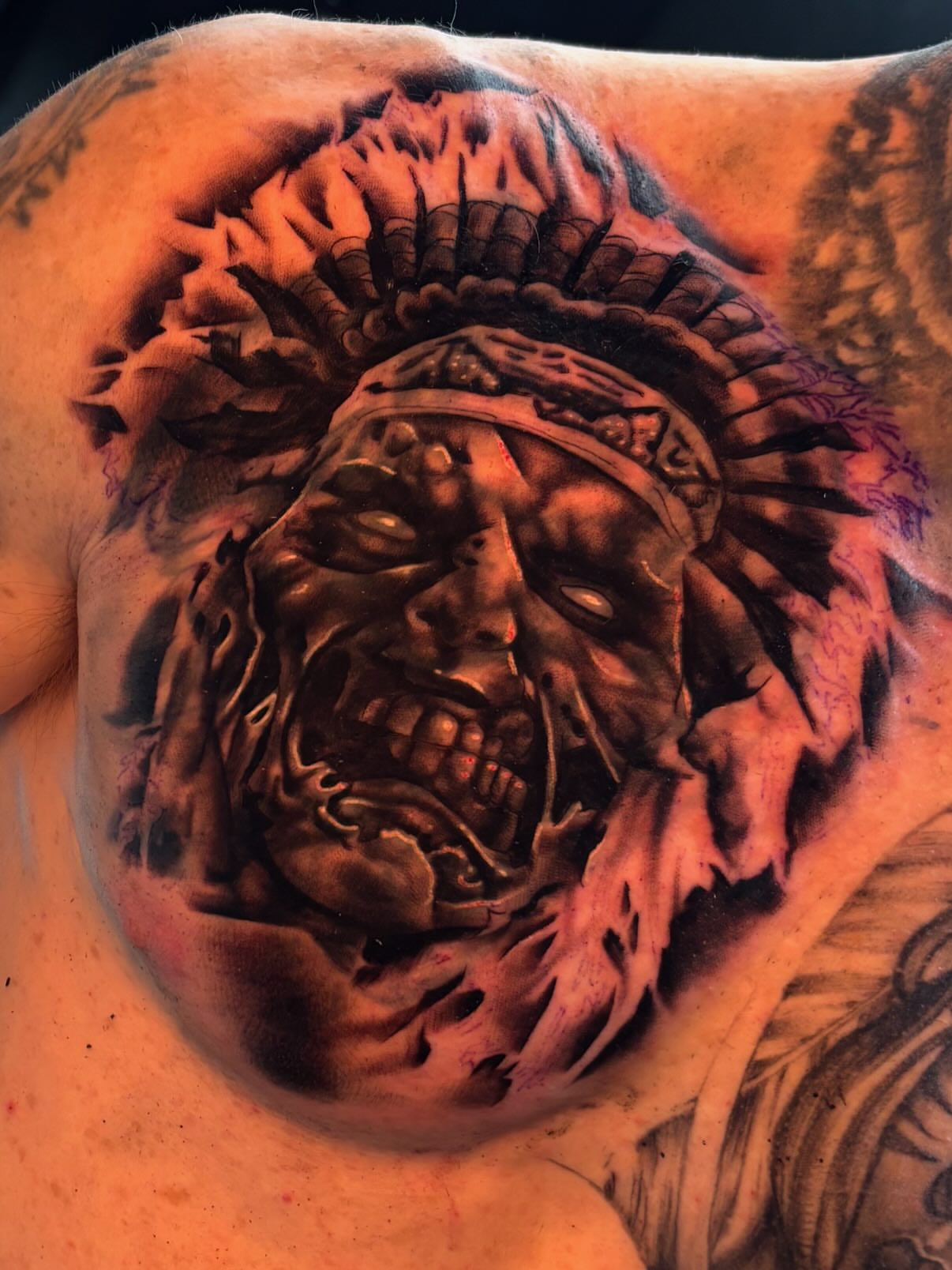 Indian chief dark realism tattoo on the chest by Bella Buonopane
