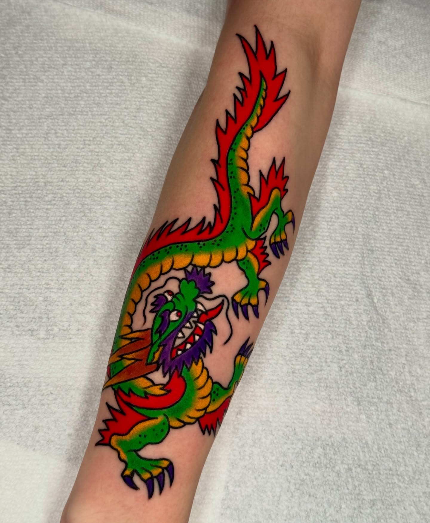 Dragon American traditional tattoo on the forearm by Joe Bear Tattooer