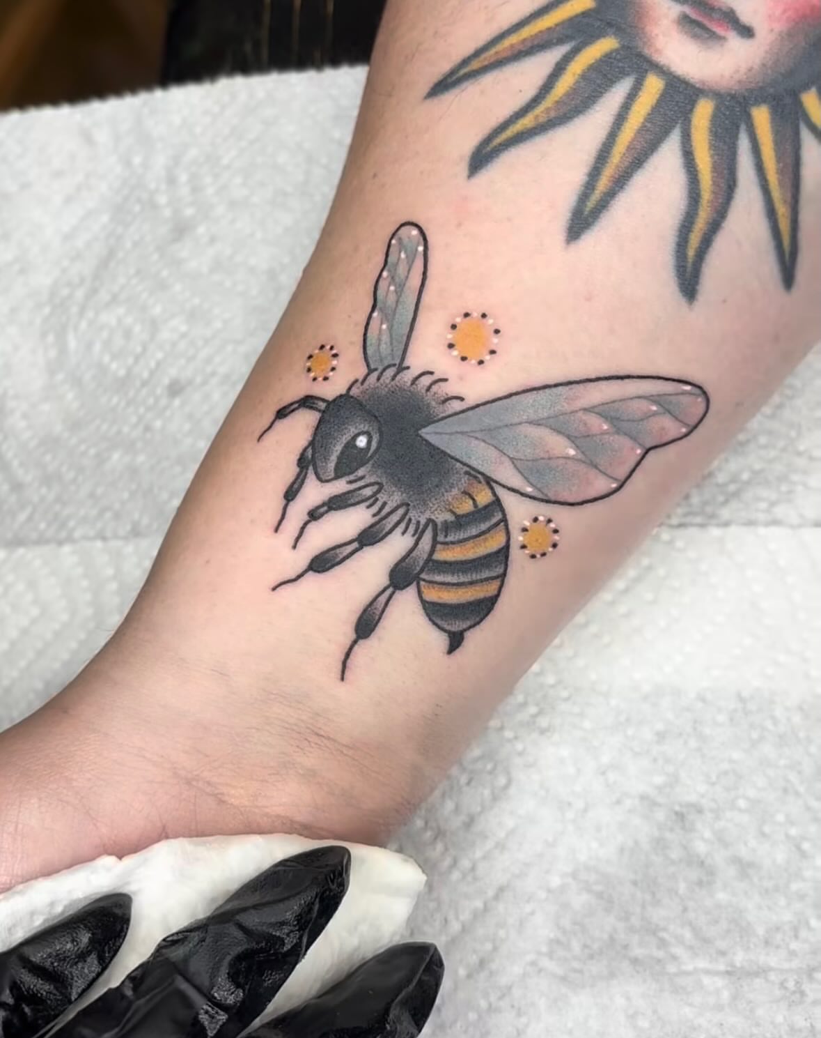 Bee American traditional tattoo on the forearm by Malia Clark