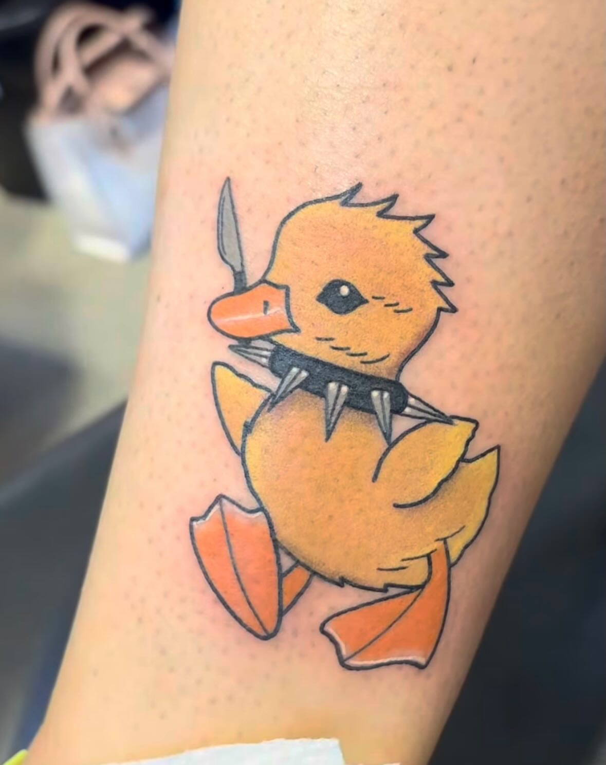 Duckling with knife dotwork tattoo on the forearm by Malia Clark