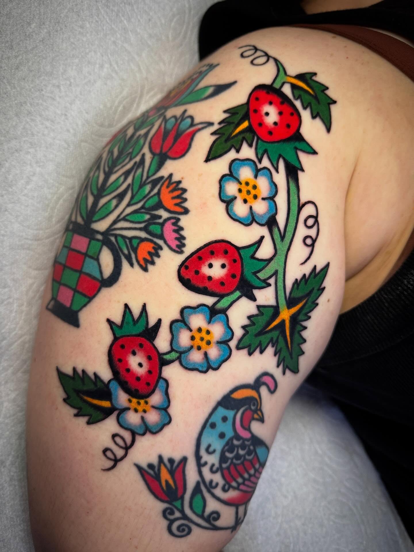 Strawberries and flowers American traditional tattoo on the shoulder by Britt Kuechenmeister, Culver City, California