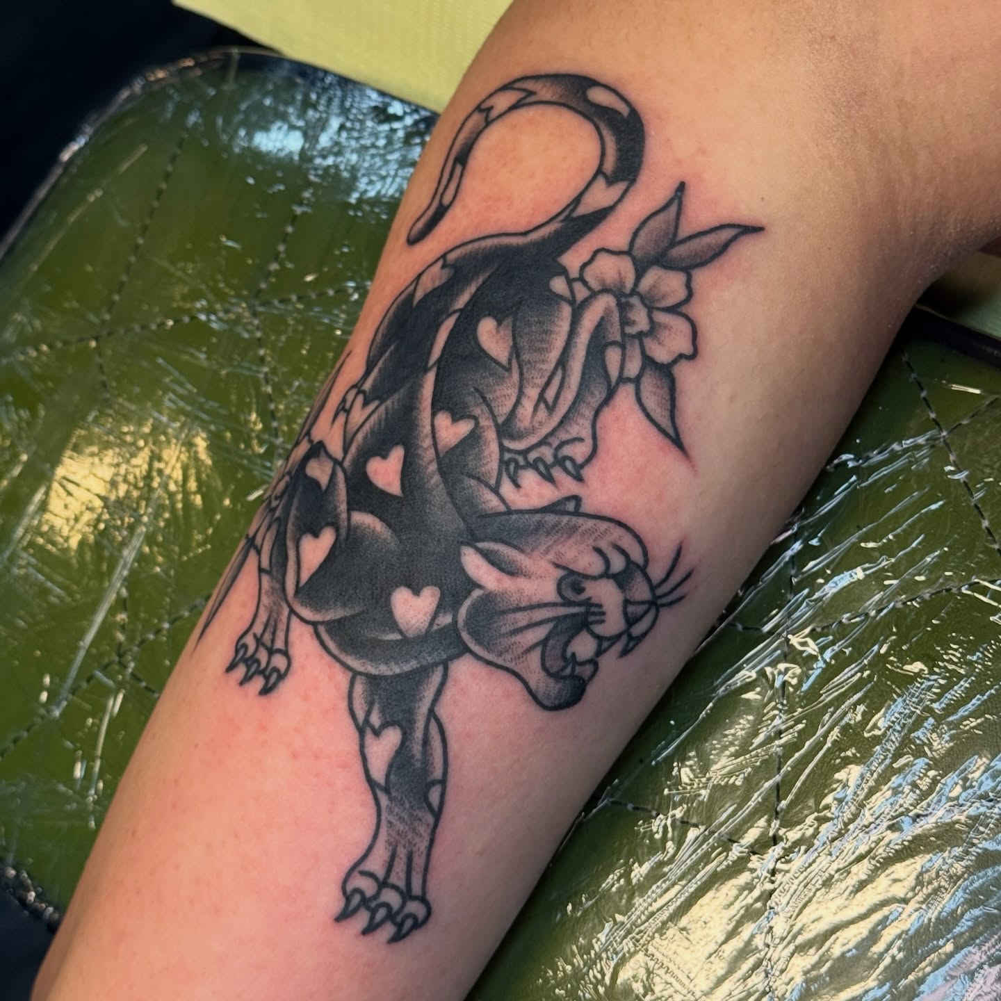 Cat and flowers black and grey tattoo on the forearm by Traddy Maddie ๐