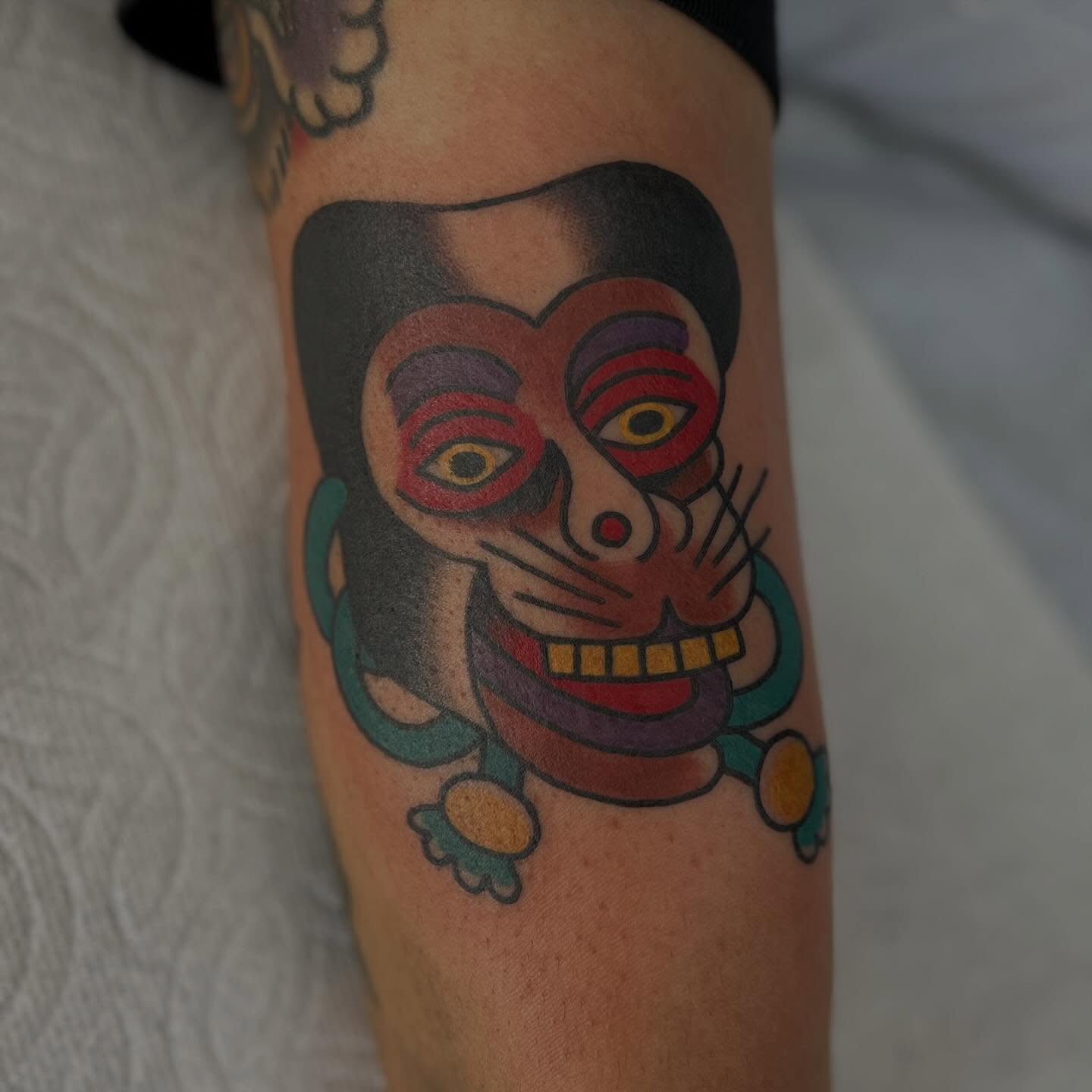 Mask American traditional tattoo on the forearm by Mikey Montoya