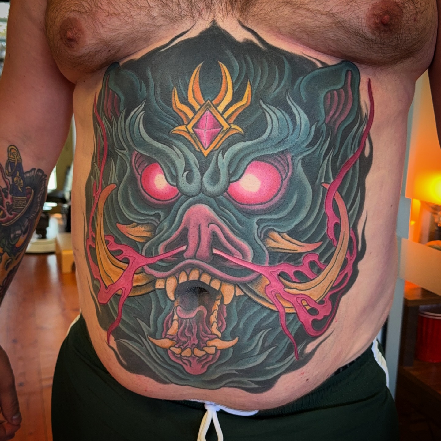Demon mask japanese irezumi tattoo on the chest by James Bird, Vancouver, British Columbia