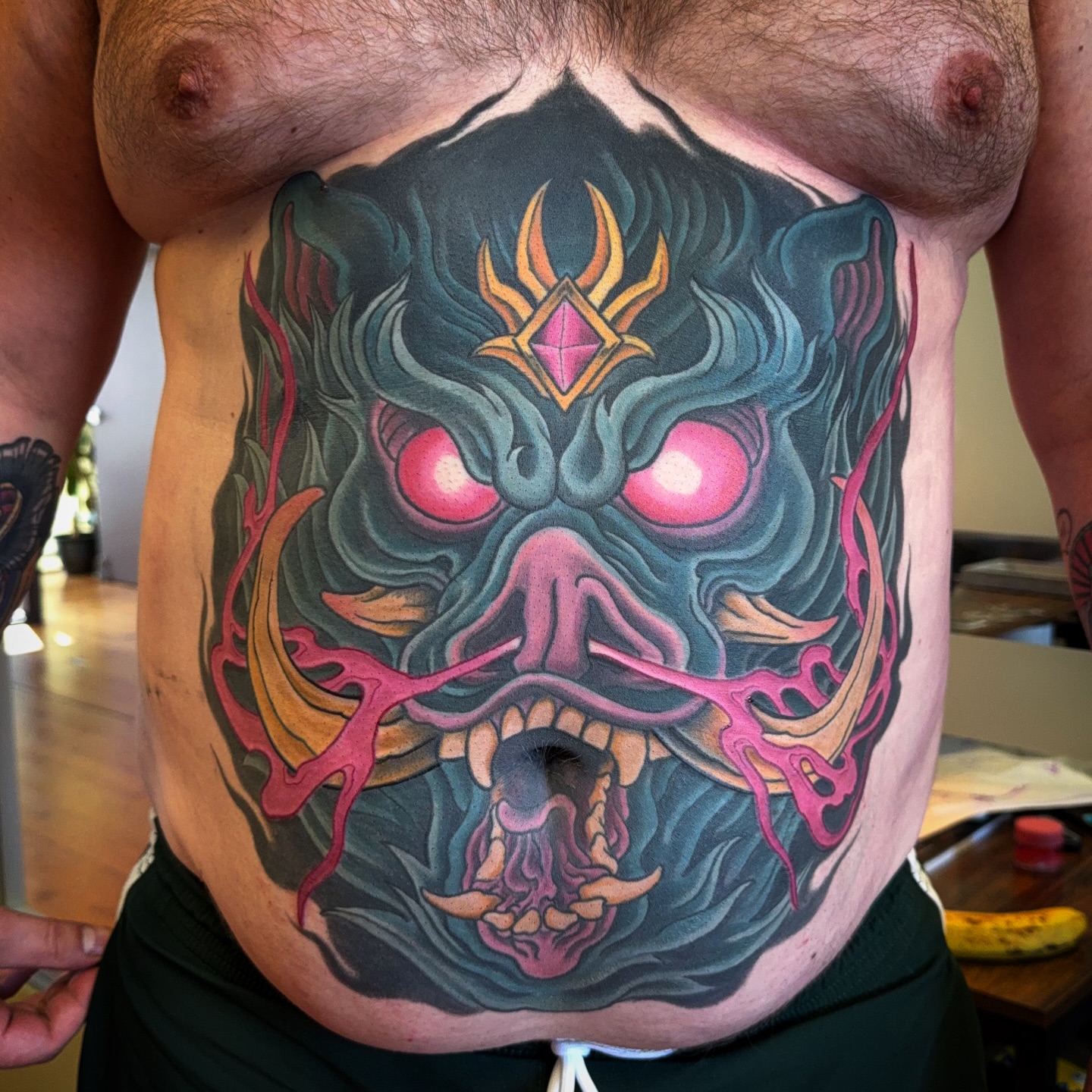 Demon mask dark realism tattoo on the chest by James Bird, Vancouver, British Columbia