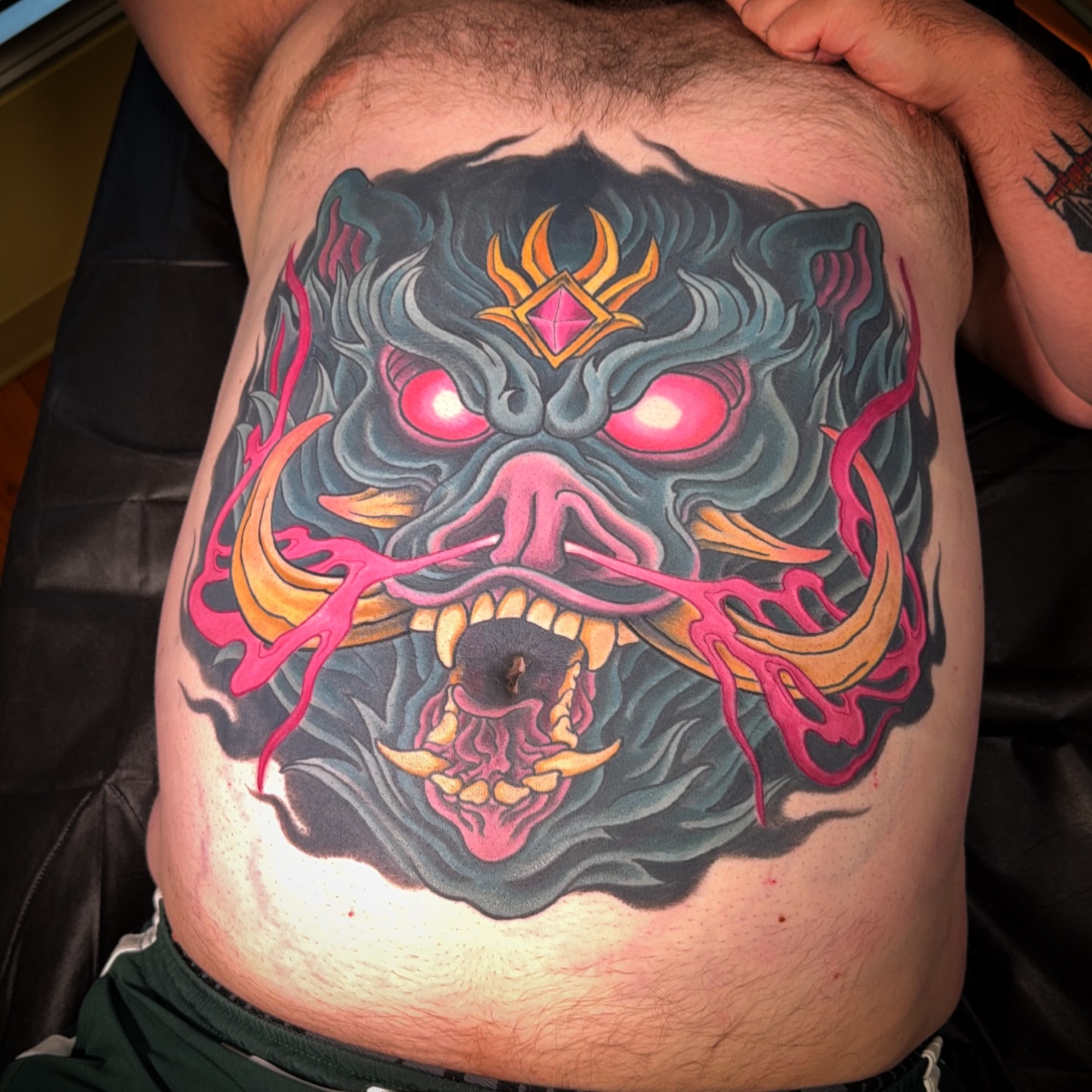 Demon mask dark realism tattoo on the chest by James Bird, Vancouver, British Columbia