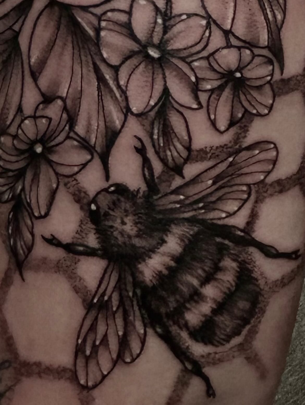 Bee and flowers black and grey tattoo on the forearm by abby ☽ marie