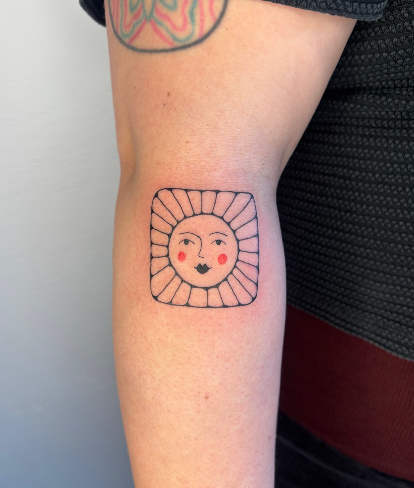 Sun geometric tattoo on the forearm by Raye