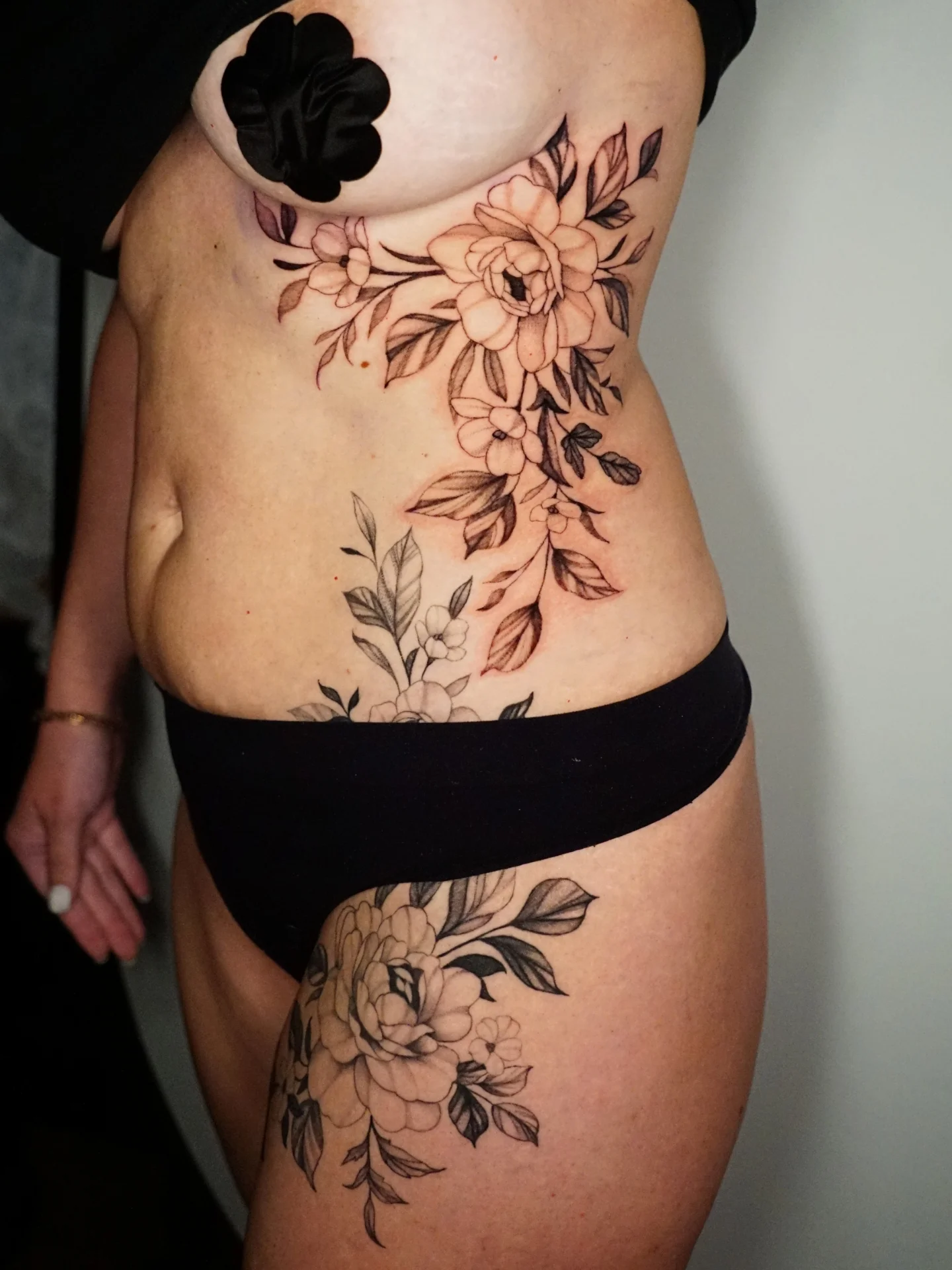 Floral bouquet black and grey tattoo on the thigh by kylie, San Antonio, Texas