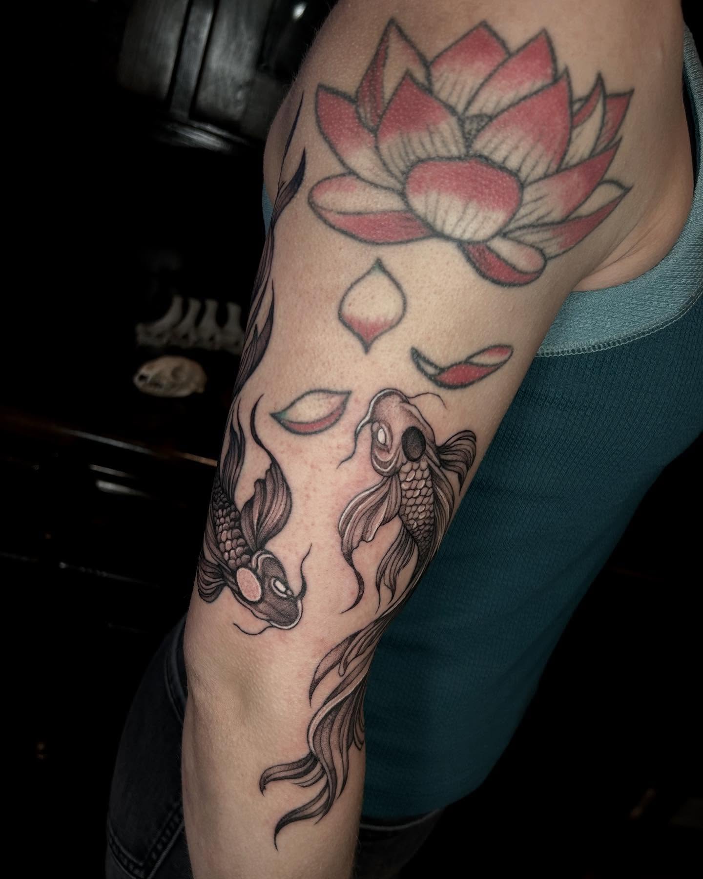 Lotus flower and koi fish black and grey tattoo on the forearm by Deanna Louise