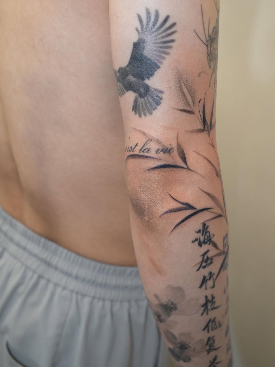Eagle, bamboo, and script sketch tattoo on the forearm by Tomato